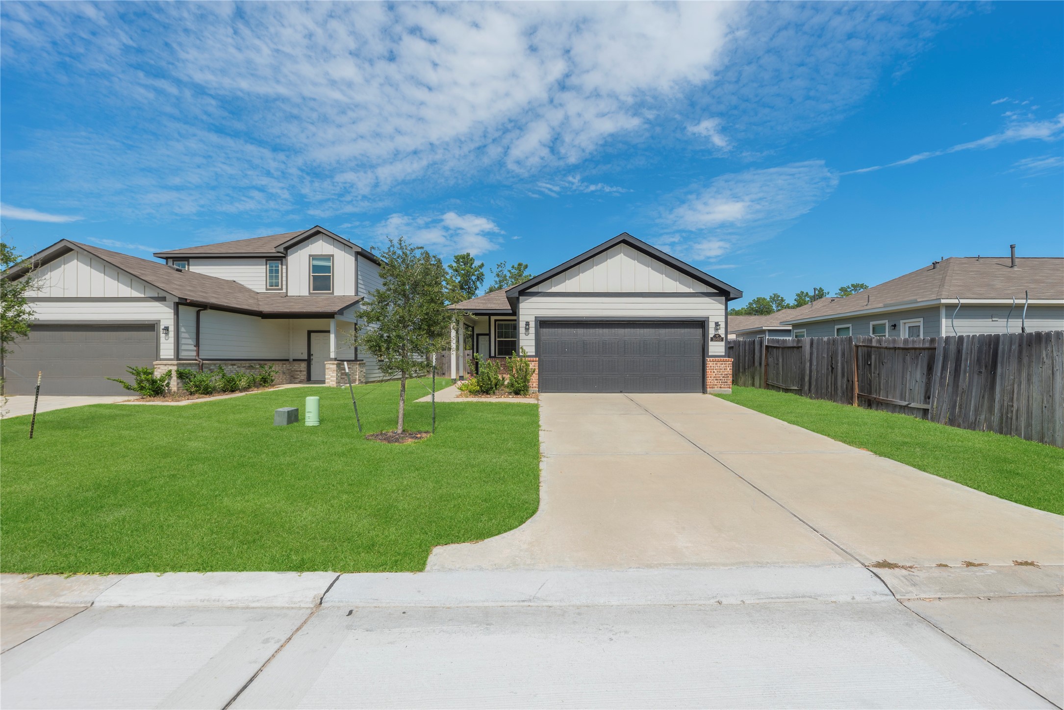 Set back from the street, the home pairs an open front lawn with a long driveway and a welcoming approach to the covered entry.