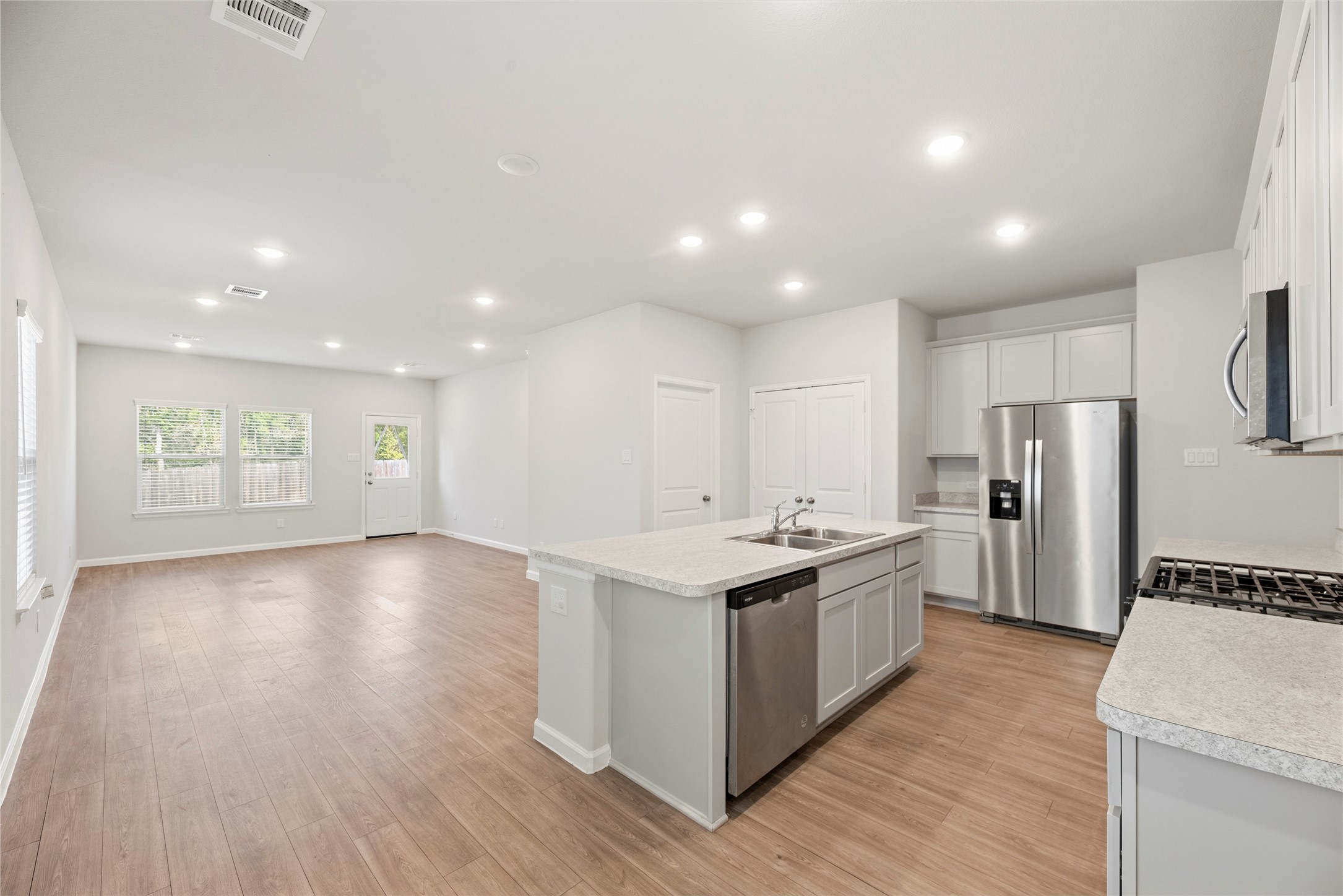 The kitchen and living area come together in one open gathering space, keeping conversation flowing whether you are preparing dinner or catching up with guests.