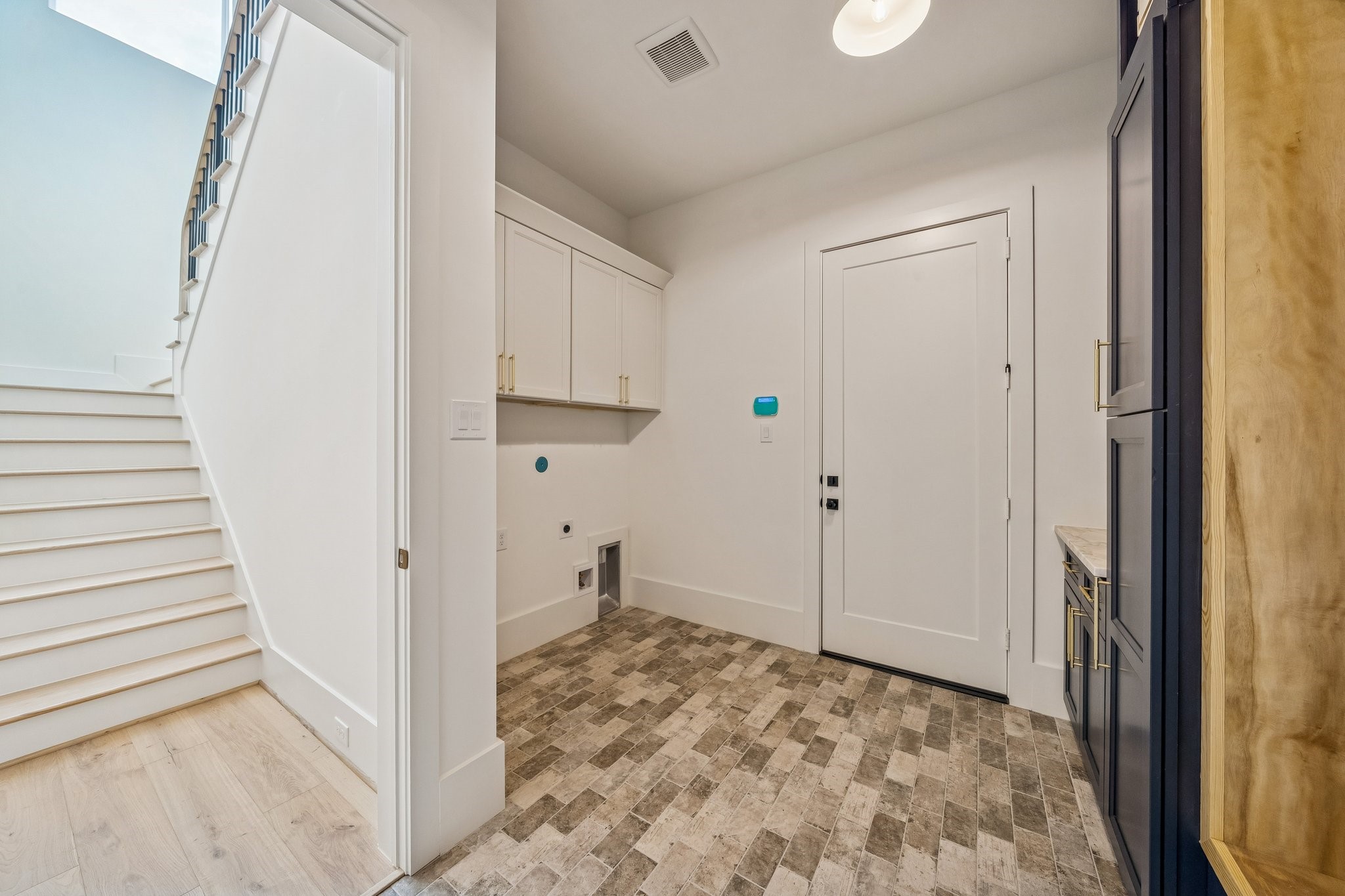 The washer and dryer has a home in the mudroom. Easy to access from the upstairs bedrooms as well as the primary.