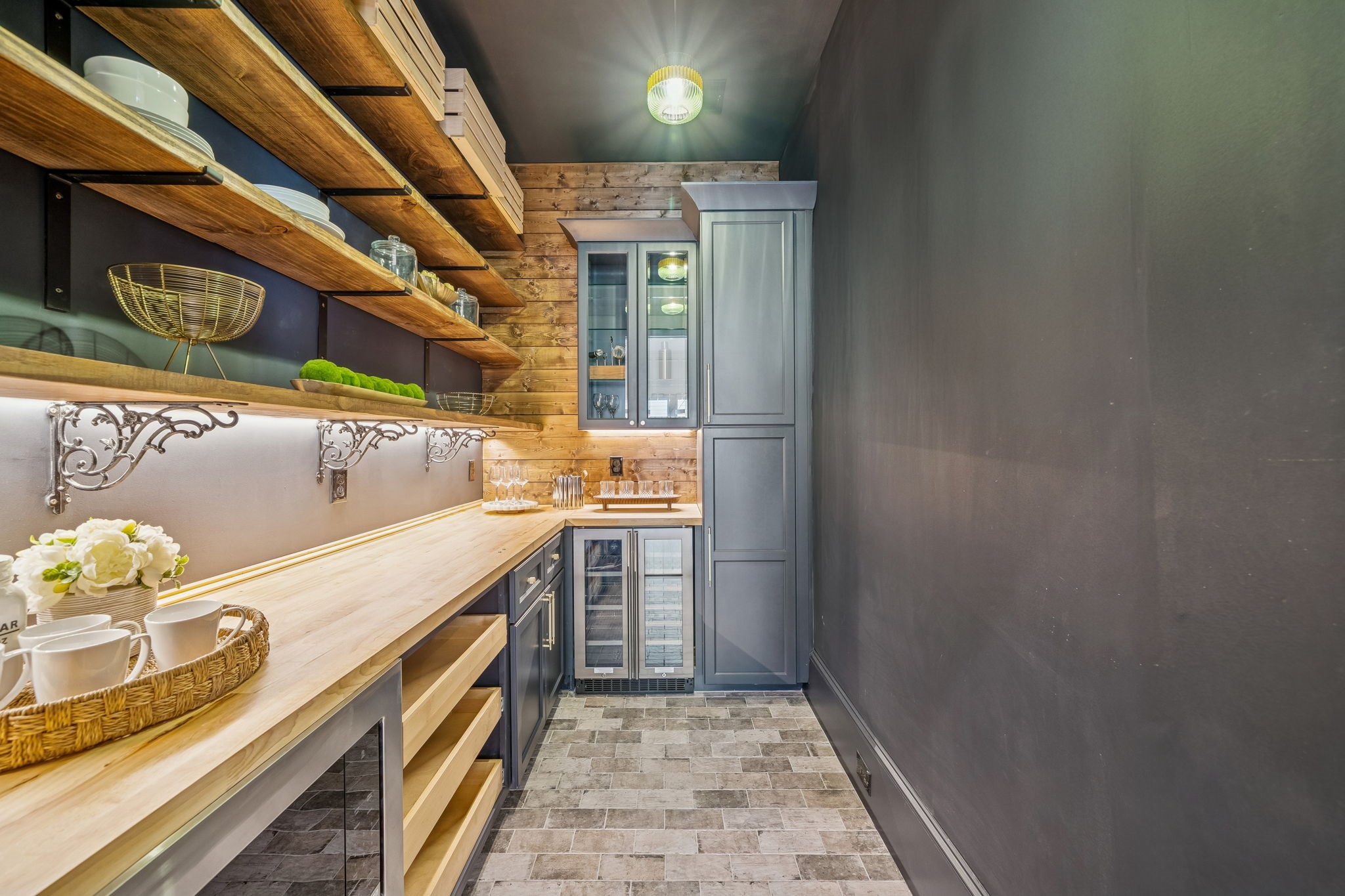 Have you ever seen a pantry like this? A pocket door separates it from the kitchen. Beverage fridge and glass cabinets for your barware. (Currently has a wallpaper accent wall not shown)
