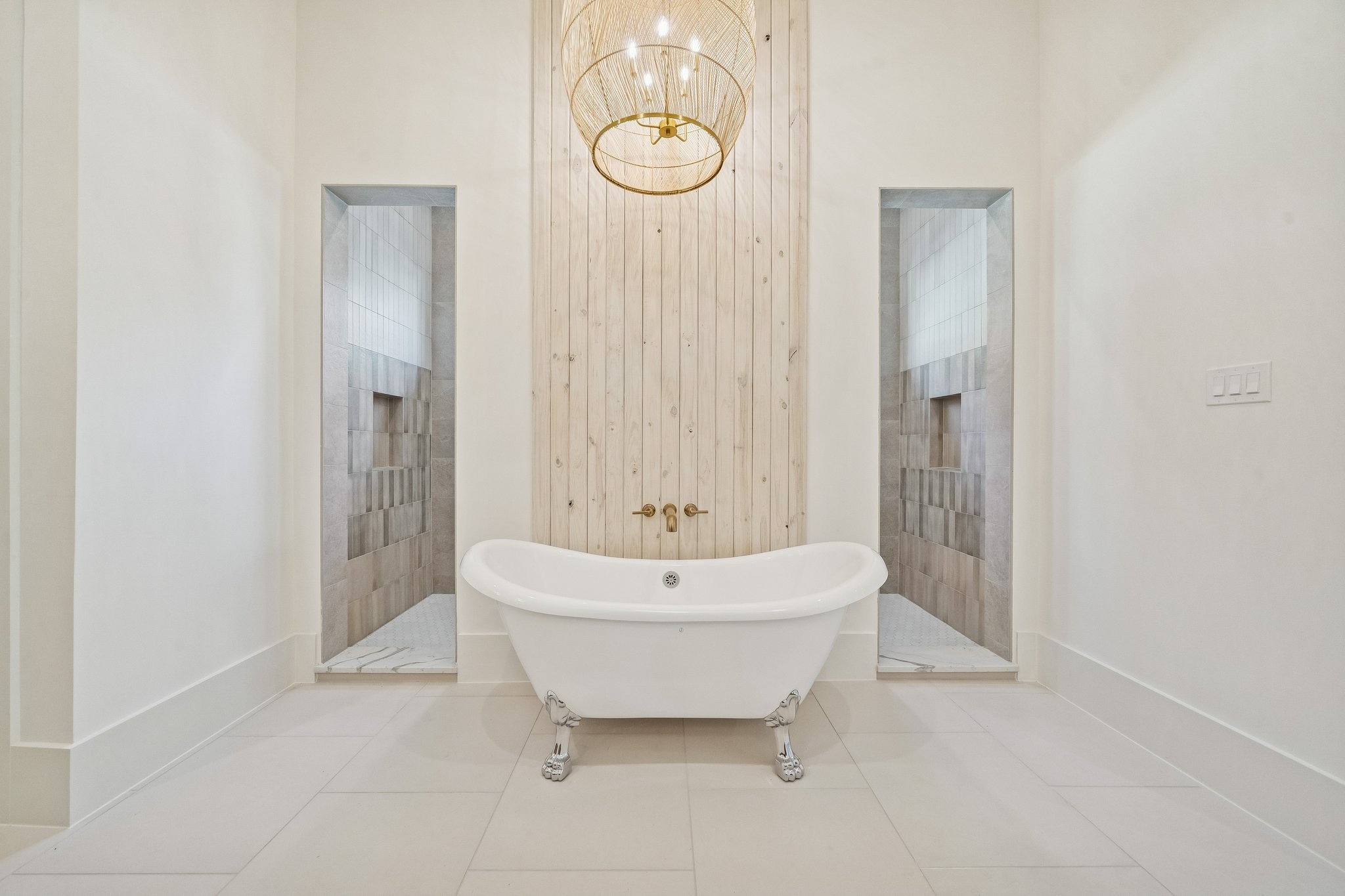 Clawfoot tub with a wall of shoji washed wood and an oversized accent light above. The shower is behind the wall.