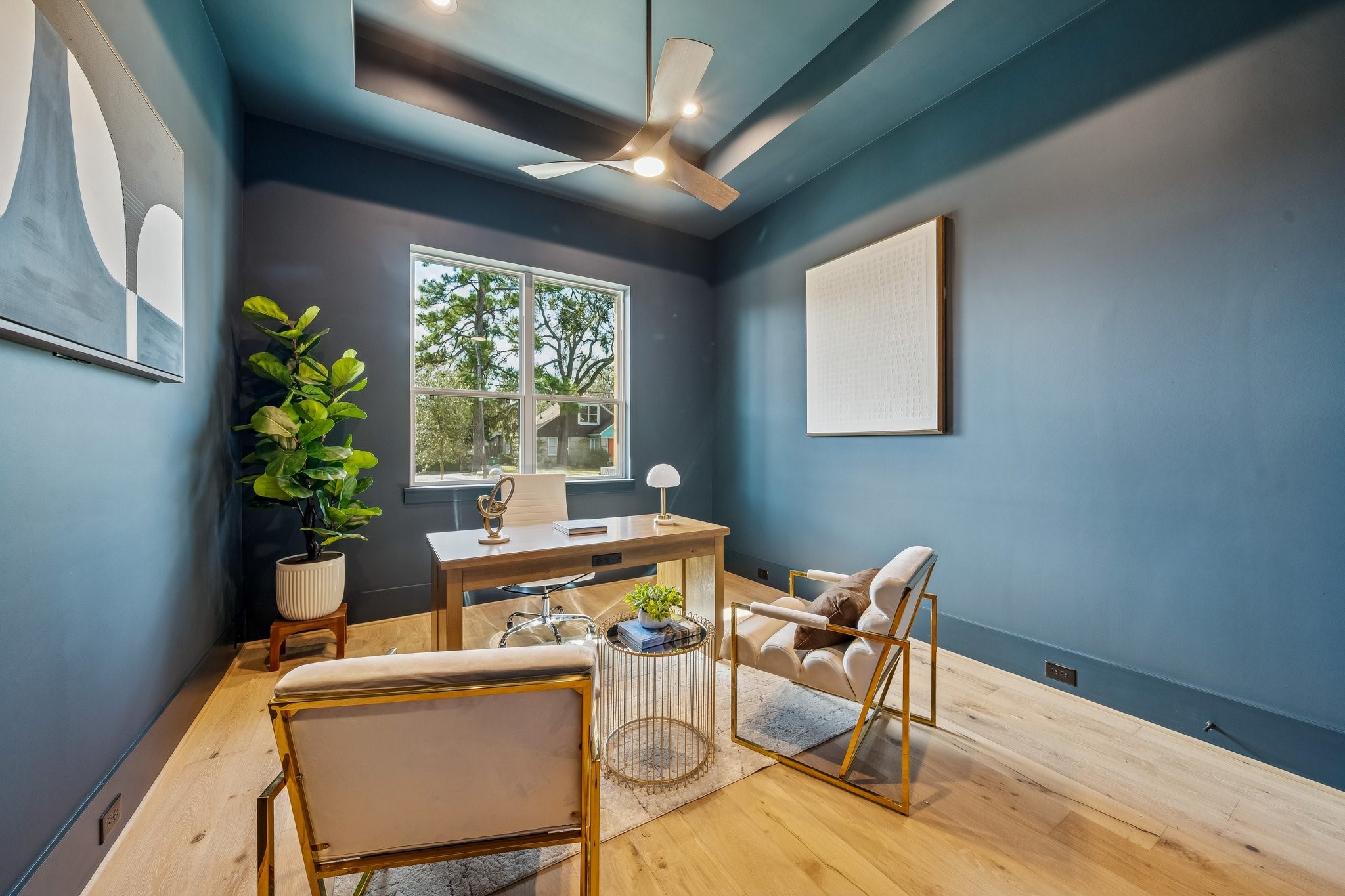 The rich navy blue walls in this downstairs secondary bedroom/study give it a sophisticated vibe. It includes a large closet and an adjacent guest bathroom.