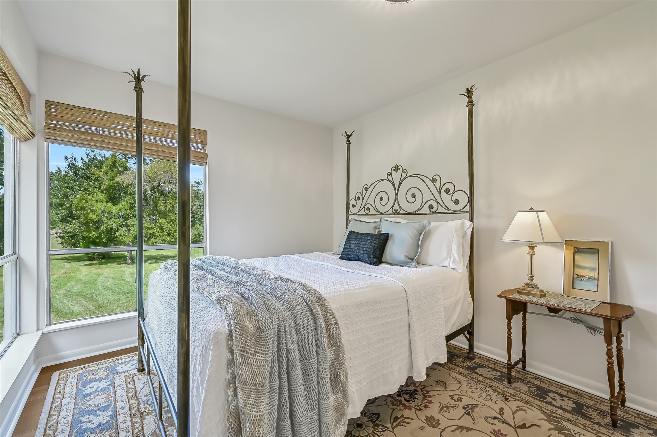 The remaining secondary bedroom enjoys beautiful views across the property through two oversized corner windows. Luxury vinyl plank flooring, neutral walls, updated lighting & a walk-in closet complete the room, which shares a Jack & Jill bathroom with the previous bedroom.