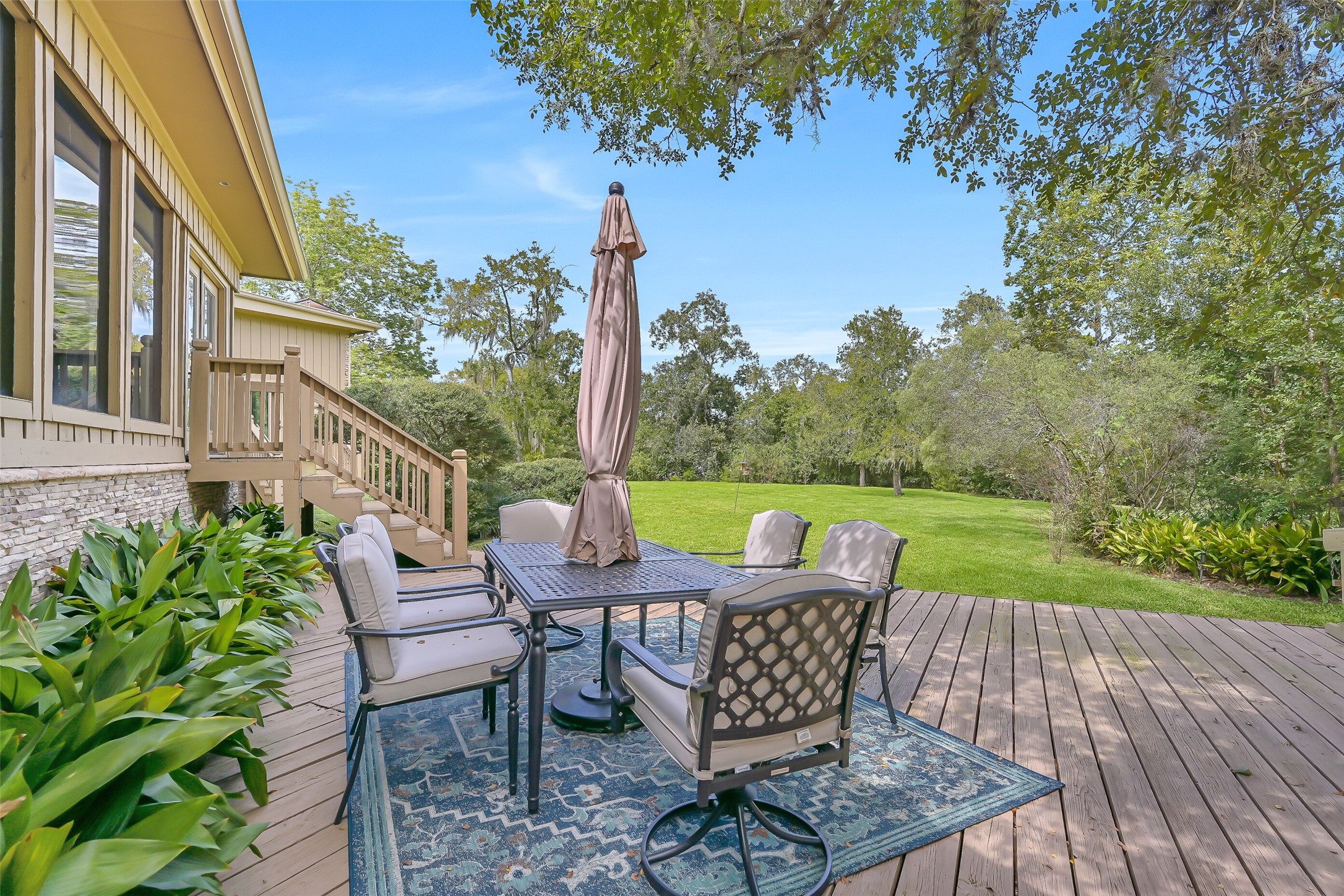 Designed to take advantage of the beautiful surroundings, the spacious rear deck offers multiple areas for gathering, grilling or simply relaxing outdoors. A mature tree rises through a thoughtfully designed opening in the decking, adding to the character of this exceptional outdoor space.