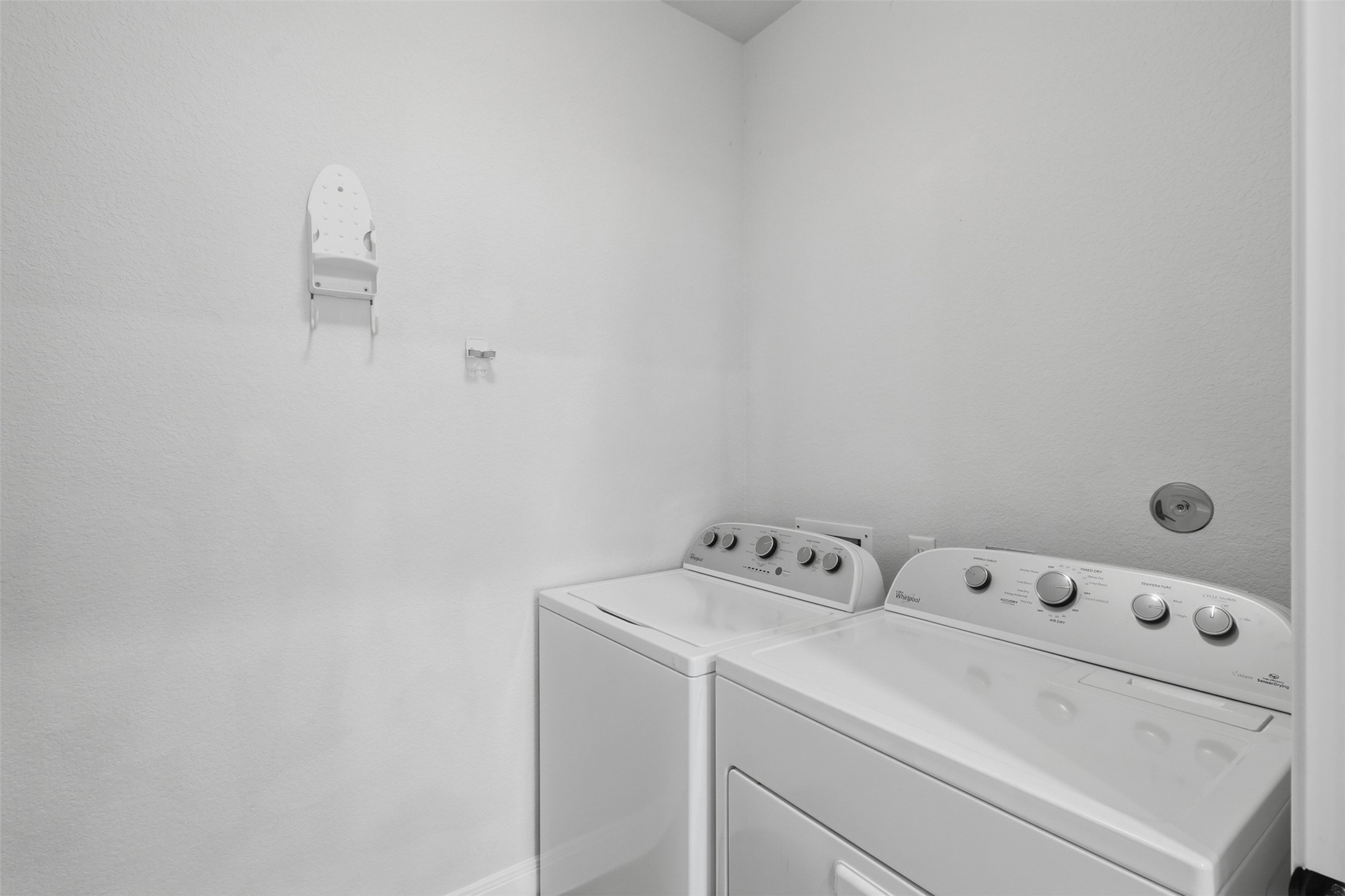 Laundry area w/ folding cabinet.