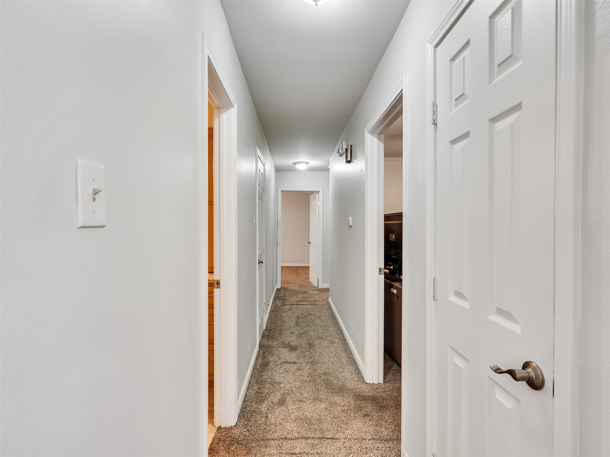 This Hallway leads to 3 bedrooms downstairs and 2 baths.