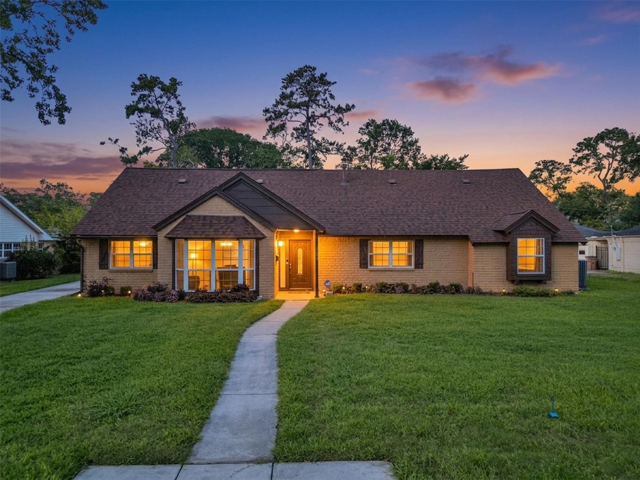 A stunning story-and-a-half family home glows beautifully at twilight, welcoming you with warm lighting, timeless curb appeal, and plenty of space for everyday living and entertaining. A stunning story-and-a-half family home glows beautifully at twilight, welcoming you with warm lighting, timeless curb appeal, and plenty of space for everyday living and entertaining.