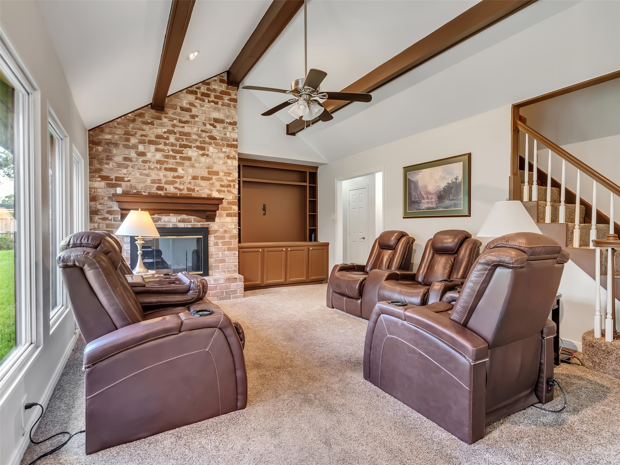Cozy nights start here. This inviting living room features a beautiful brick fireplace that adds warmth, charm, and the perfect focal point for gathering with family and friends.