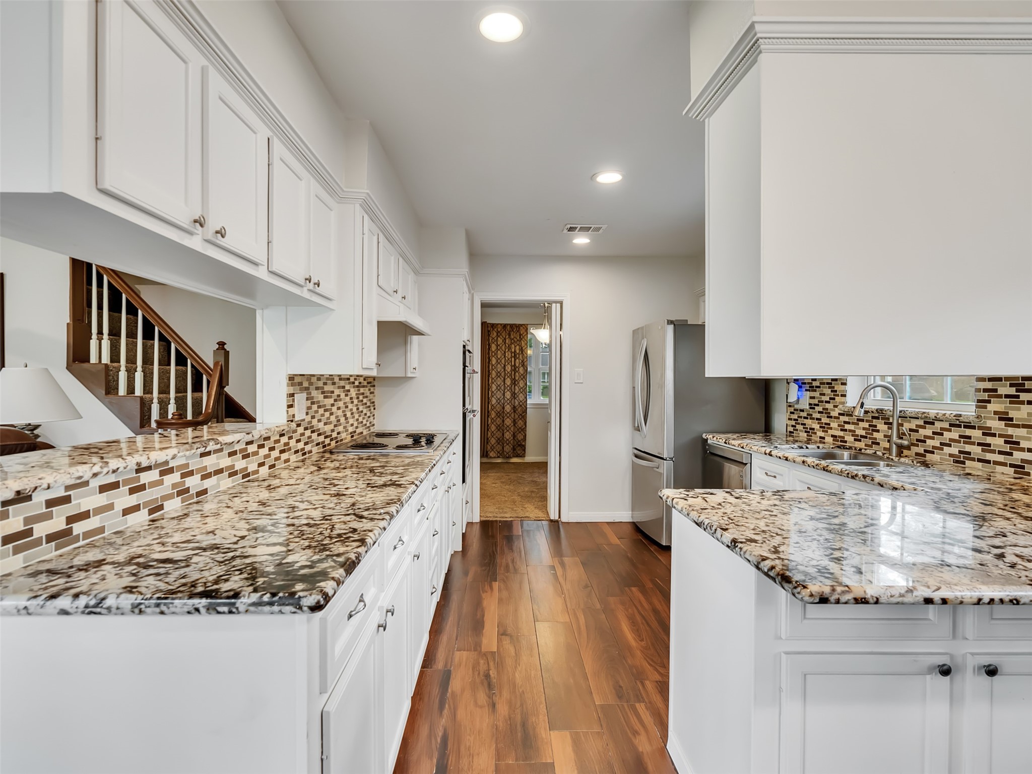 This open-concept kitchen flows seamlessly into the living area, creating the perfect space for entertaining, gathering, and everyday connection.