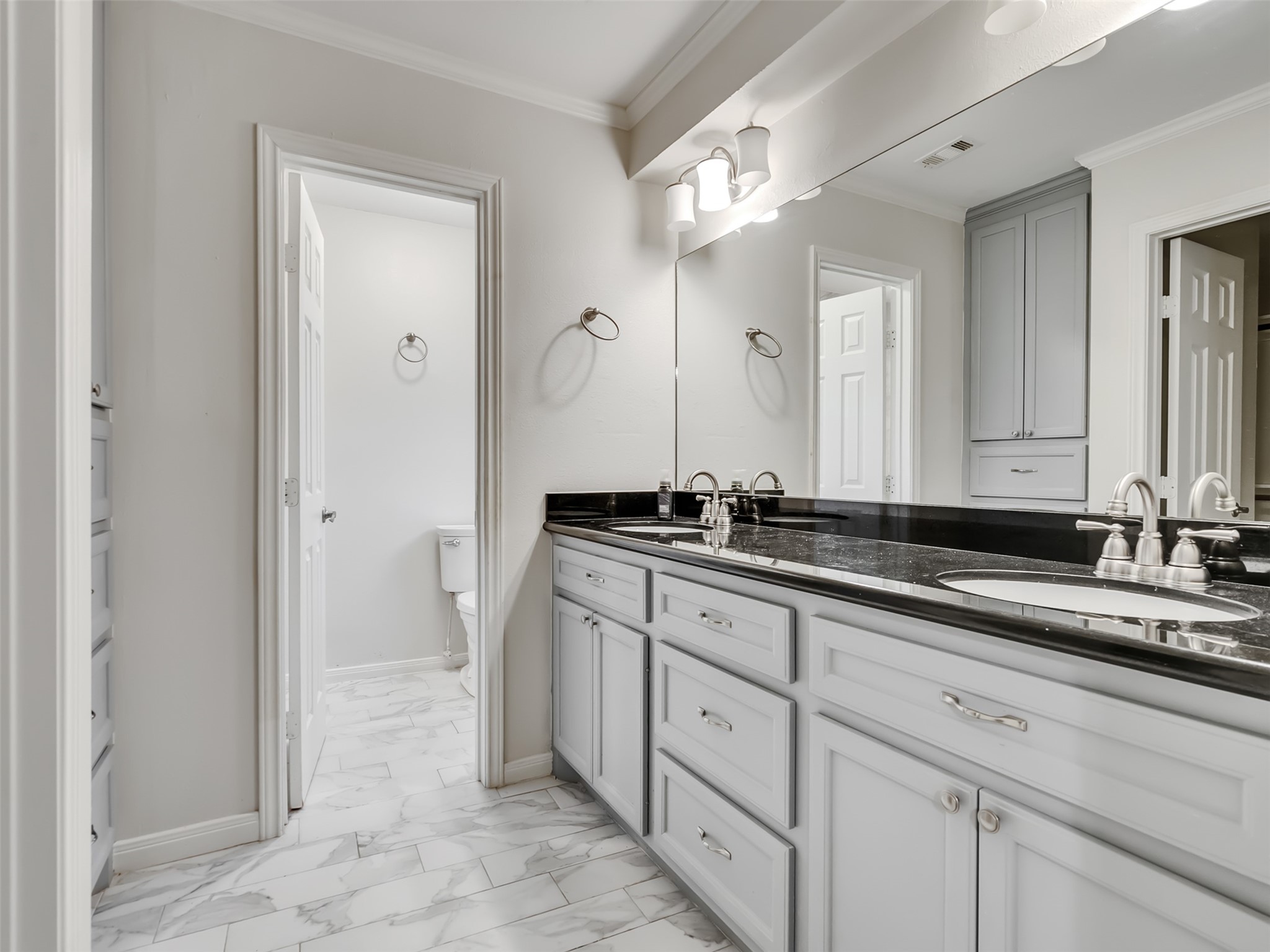 A private retreat designed for comfort and style. This beautiful primary bath features granite countertops, dual sinks, and elegant built-ins that provide both luxury and functionality.