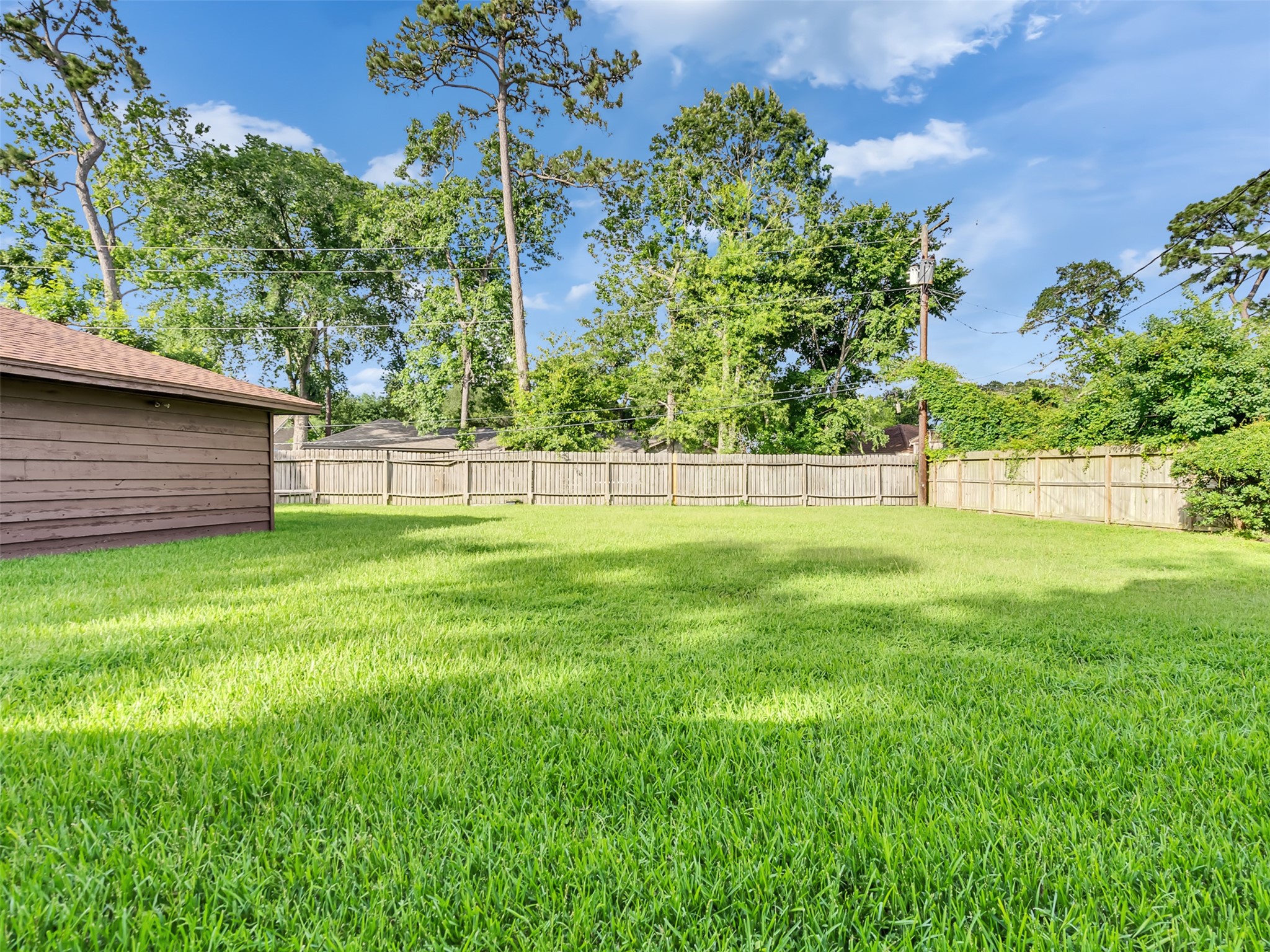 An expansive backyard oasis offering endless possibilities for outdoor living, entertaining, and relaxation. An expansive backyard oasis offering endless possibilities for outdoor living, entertaining, and relaxation.