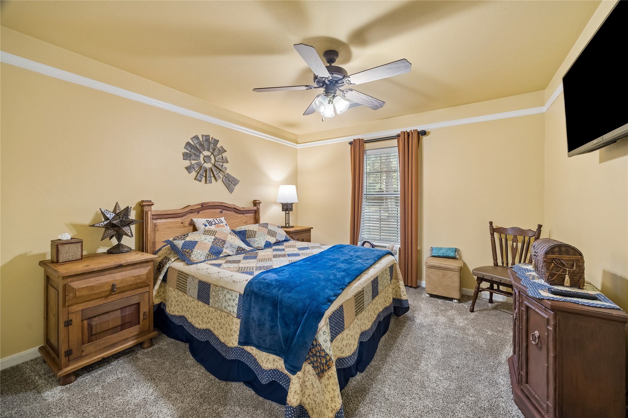 Bedroom 3 in main home with ceiling fan and crown molding.