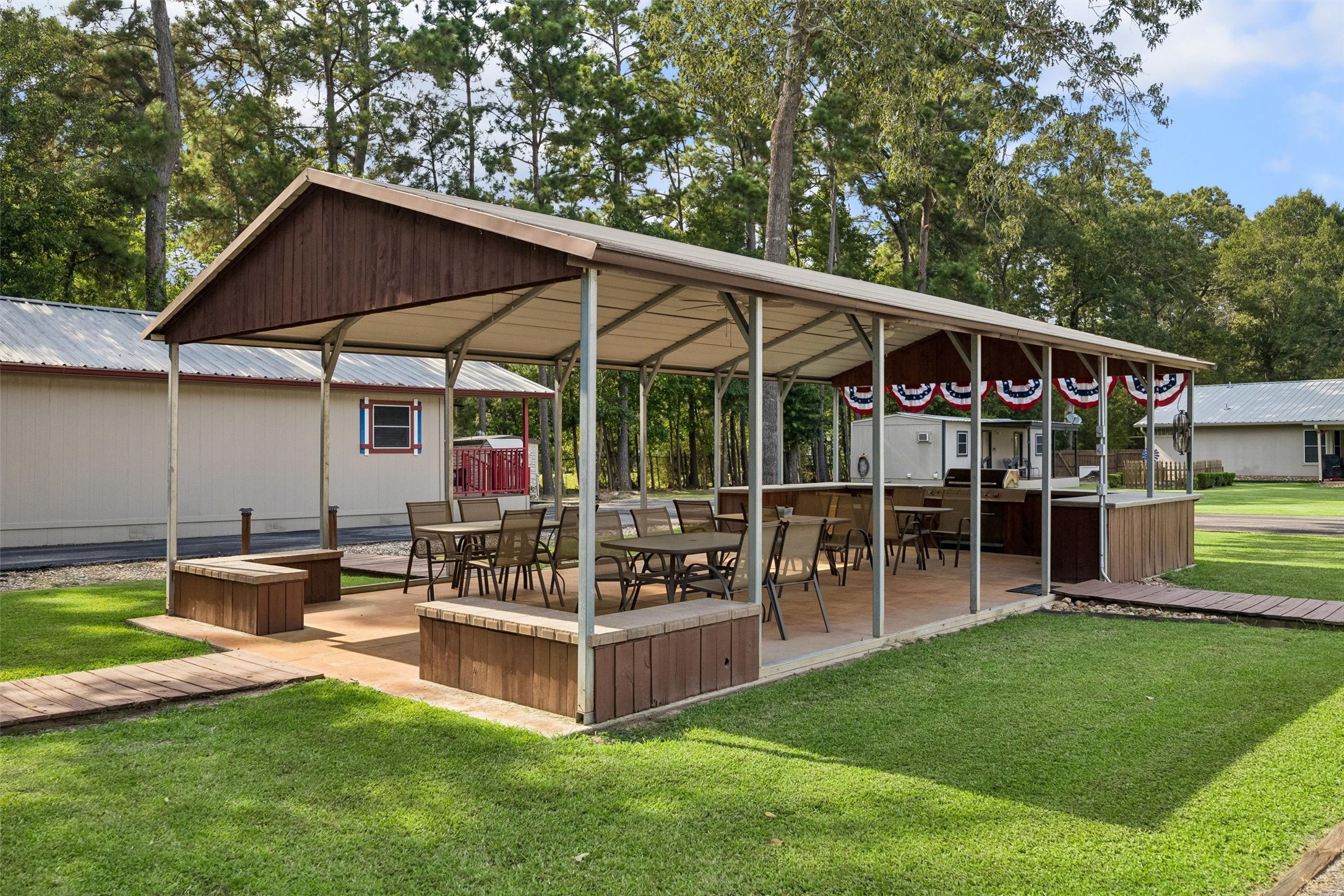 Outdoor covered pavilion complete with grill, table and chairs