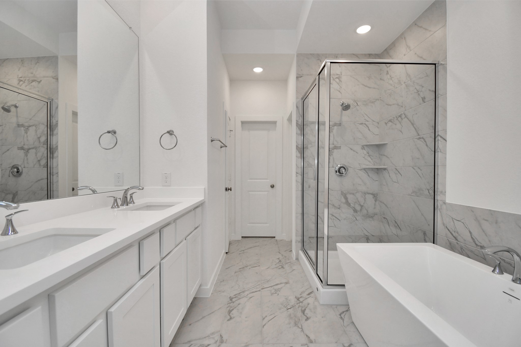 The spacious primary bathroom features a stand-up shower and a soaking tub, creating a perfect oasis for relaxation and rejuvenation.