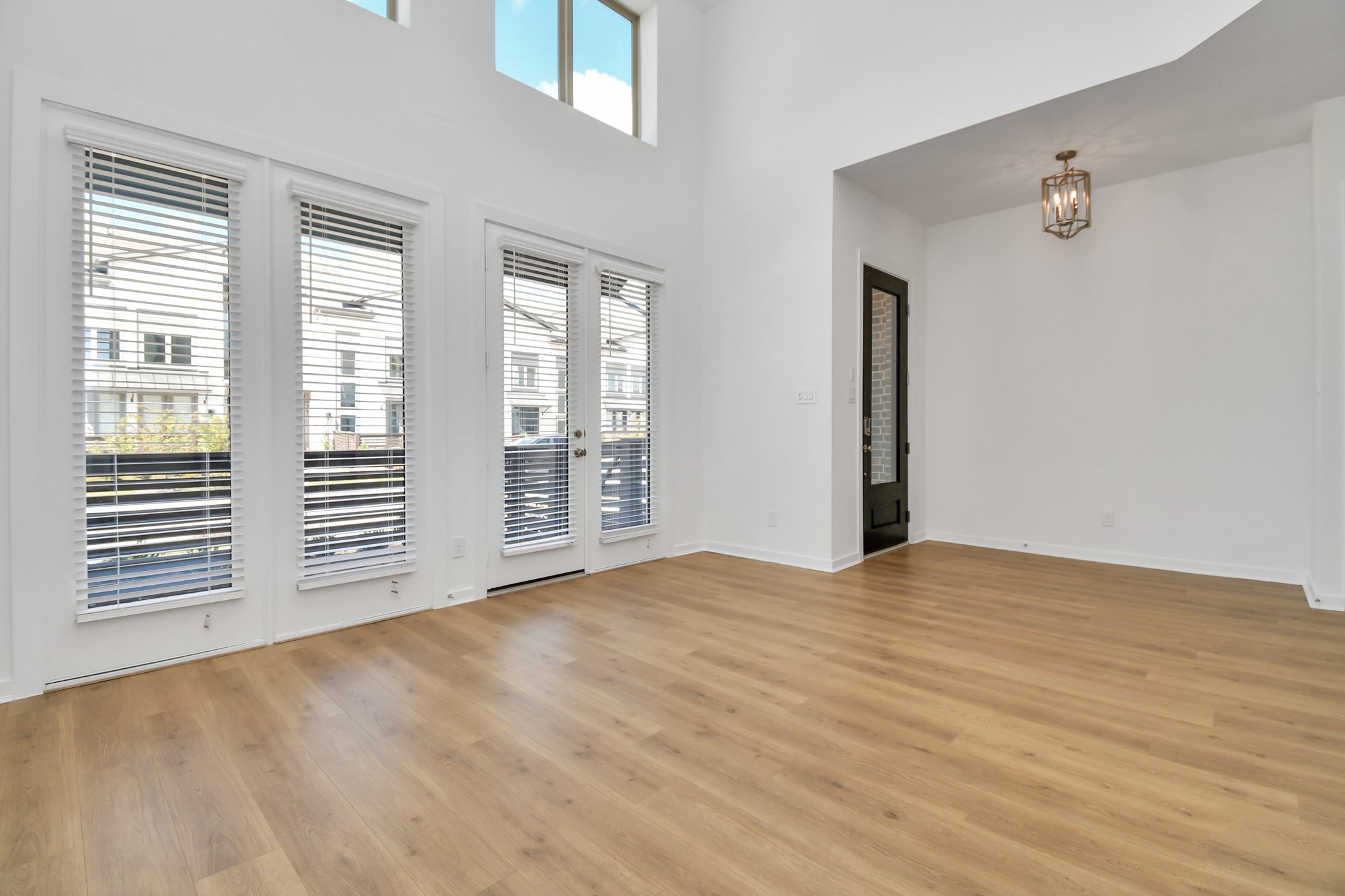 The front entry opens directly into a bright, inviting living room, seamlessly blending indoor comfort with a welcoming atmosphere.