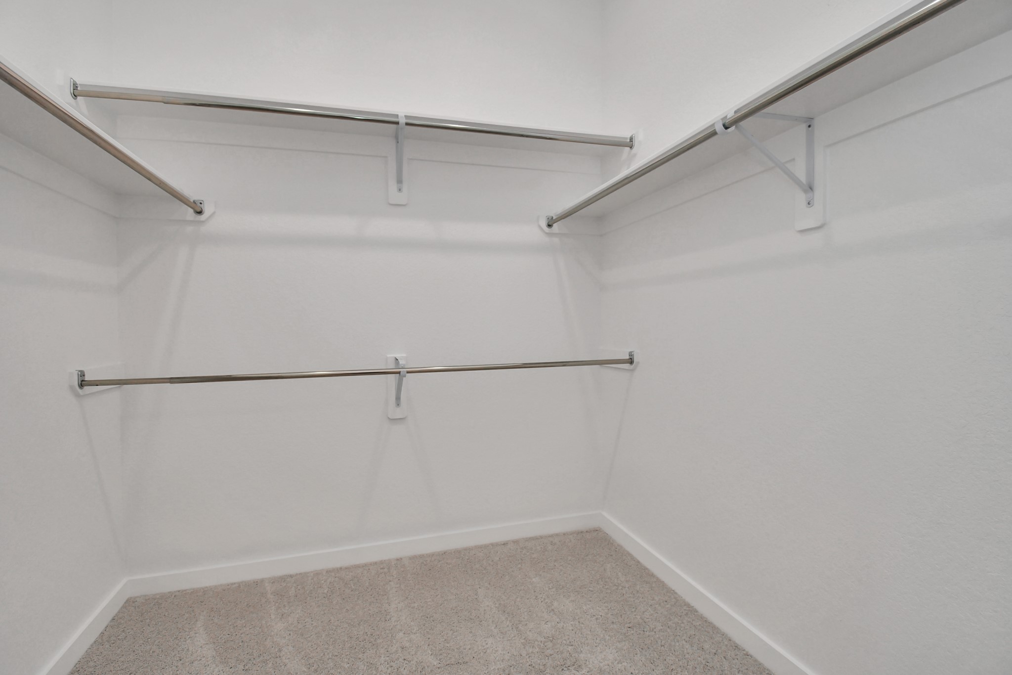 The primary bedroom includes a large walk-in closet, offering generous space.