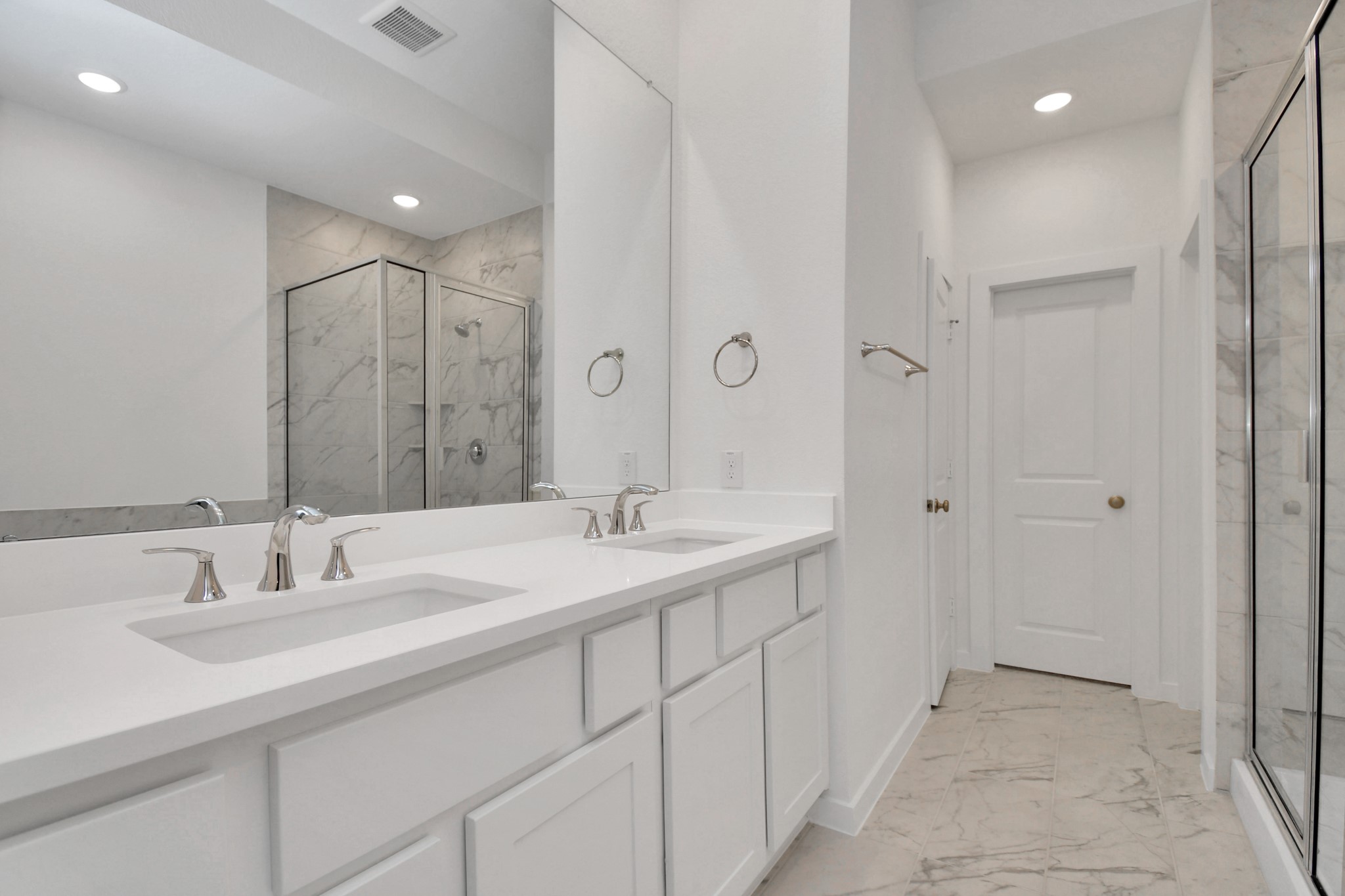 The primary bathroom features double sinks, providing ample space and convenience for a stylish and functional retreat.