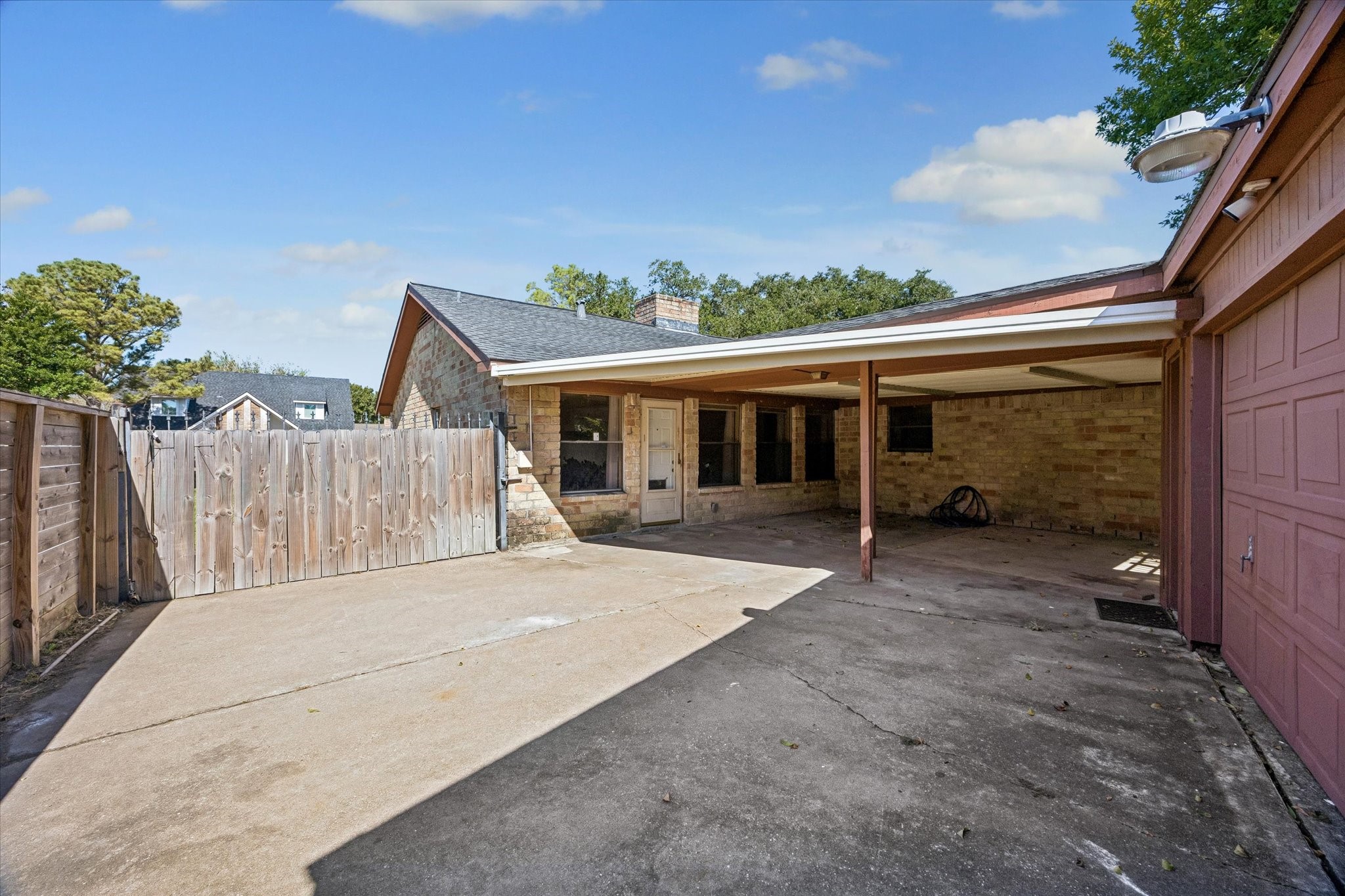 Spacious backyard with a covered patio, perfect for outdoor gatherings and ample parking space.