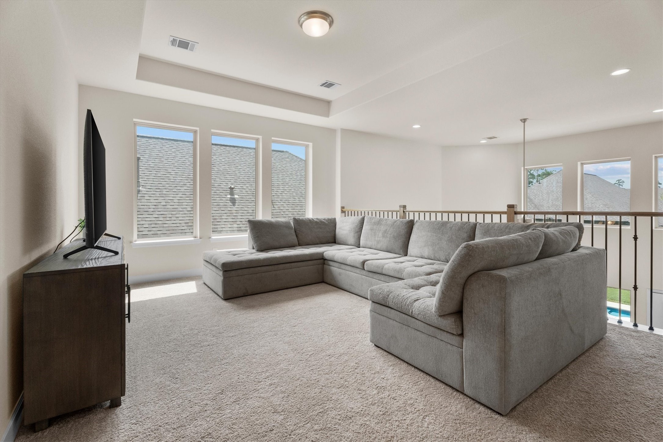A spacious game room offers endless possibilities for movie nights, play space, or a second living area.