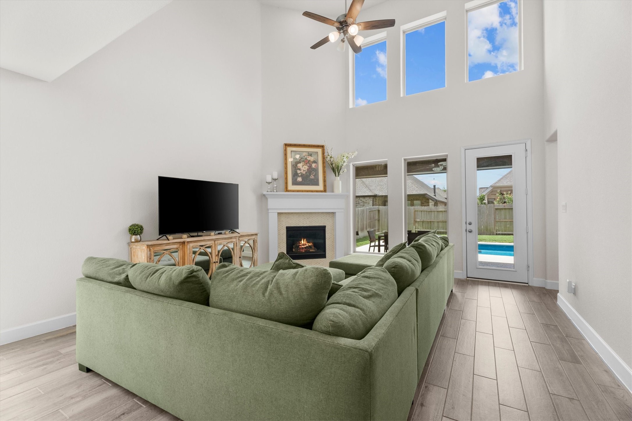 Soaring ceilings and expansive windows create a living room that feels both grand and welcoming.