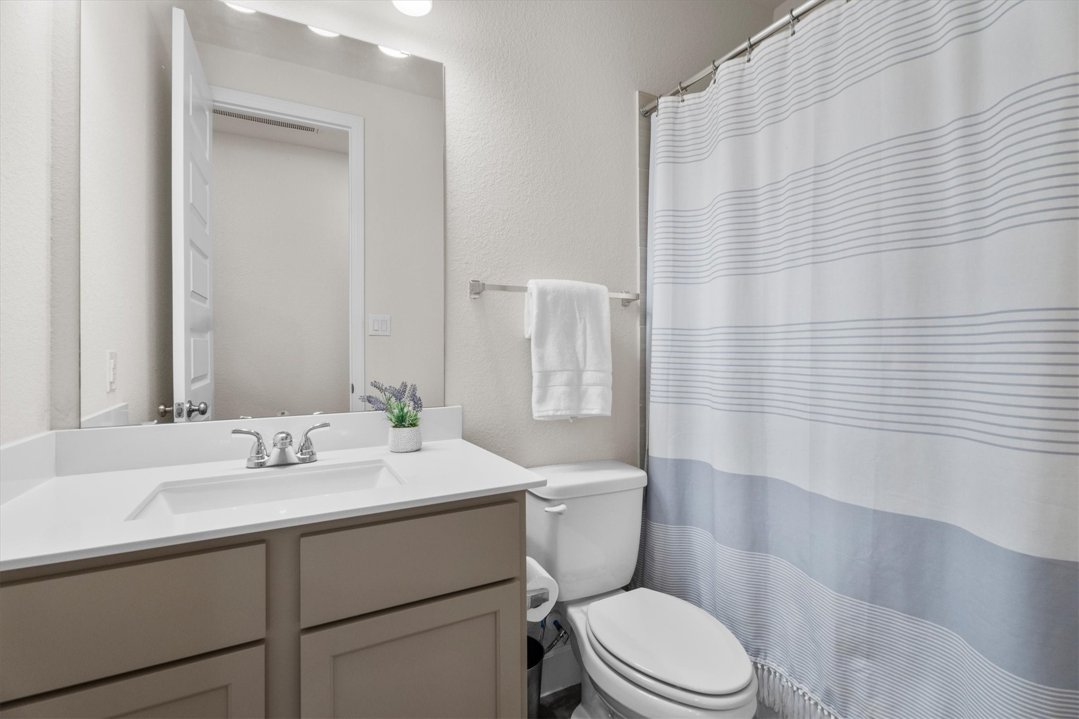 Additional full bath downstairs offers comfort and convenience for busy households.