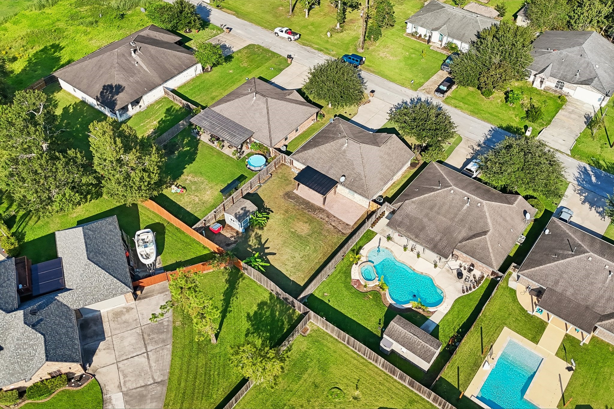 Charming neighborhood featuring spacious yards, a beautiful in-ground pool, and lush greenery, perfect for family living and outdoor activities.