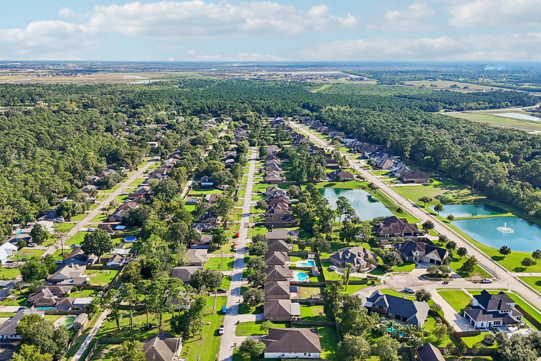 Charming neighborhood with tree-lined streets and well-maintained homes, featuring nearby ponds and lush greenery for a serene living environment.
