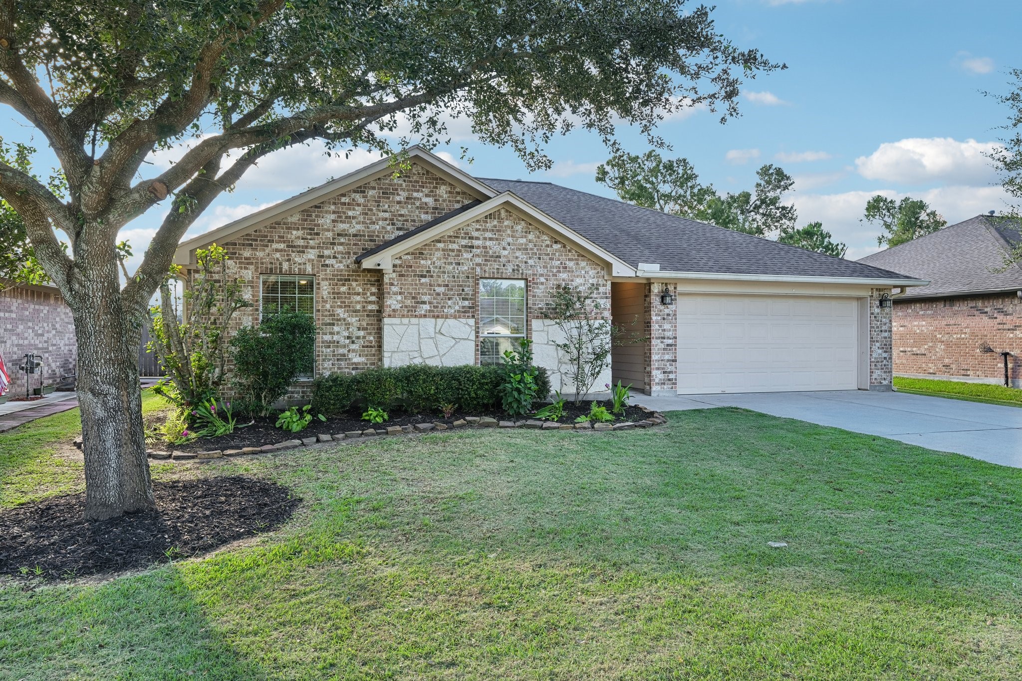 Charming brick home with a beautifully manicured lawn, shaded by mature trees, and a spacious two-car garage. Charming brick home with a beautifully manicured lawn, shaded by mature trees, and a spacious two-car garage.
