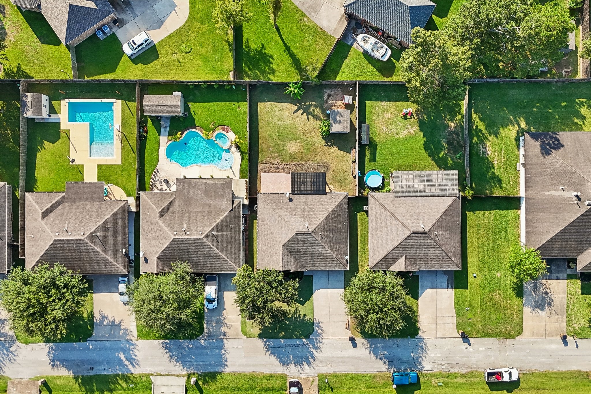 Charming suburban homes with spacious backyards, some featuring inviting swimming pools, perfect for relaxation and entertaining.