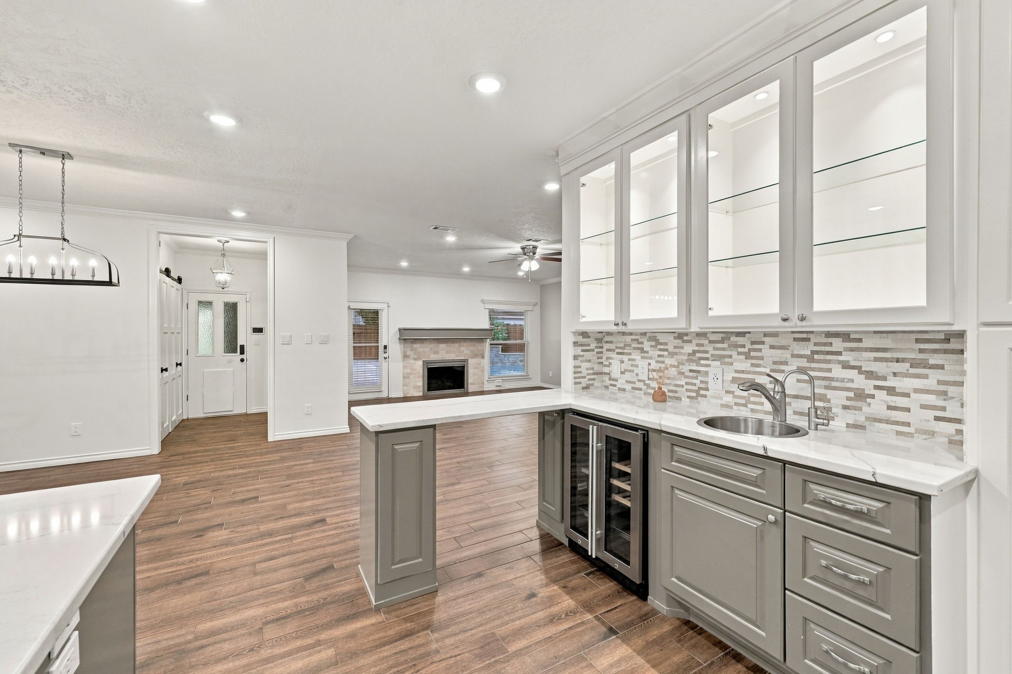 Expansive kitchen with generous counter space, a central island, stainless steel appliances, and open living areas.