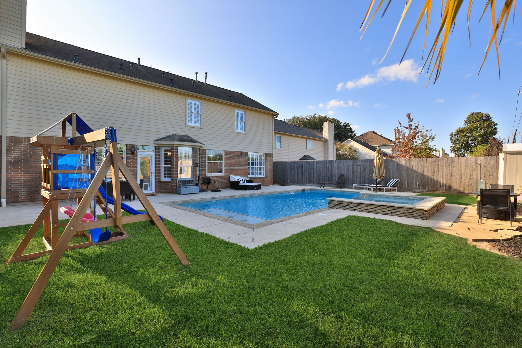 A backyard designed for enjoyment, featuring a generous green space for outdoor play.