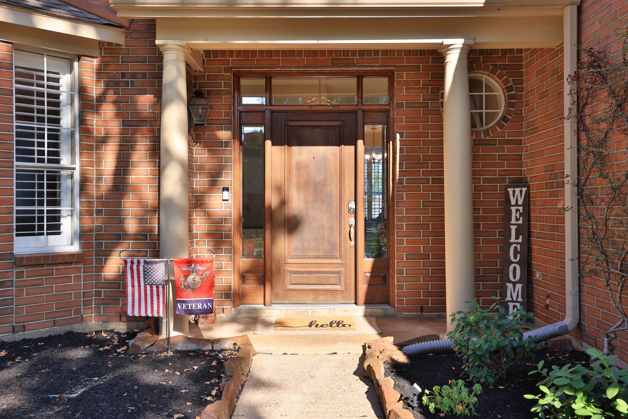 An inviting covered entry features stately columns, a rich wood door, and elegant glass sidelights. An inviting covered entry features stately columns, a rich wood door, and elegant glass sidelights.