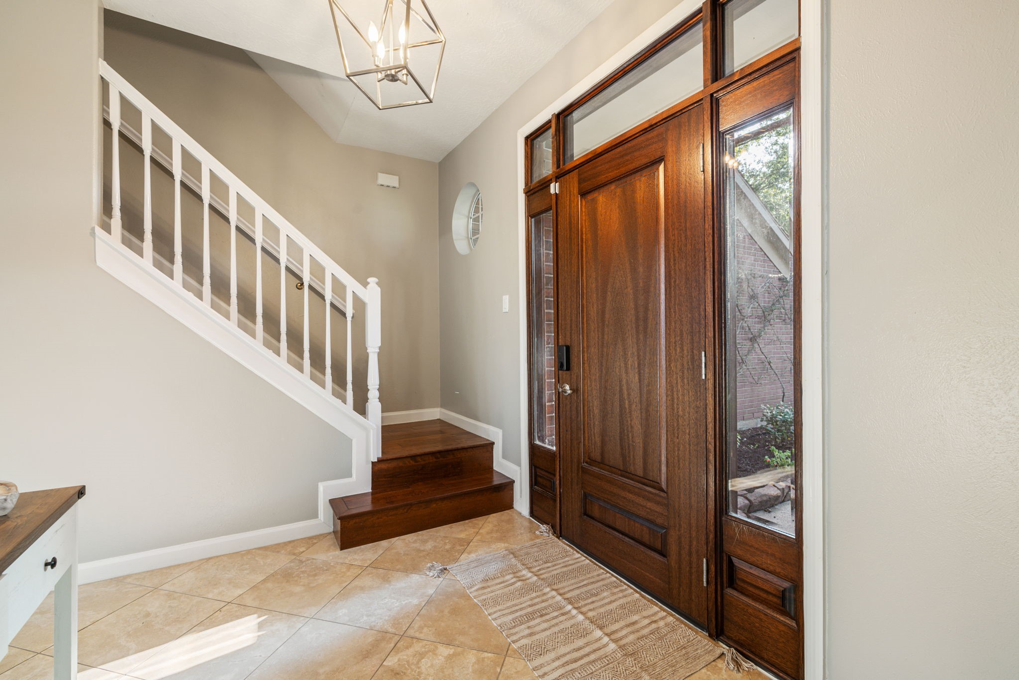 A handsome wood entry door, classic staircase, and contemporary lighting create an elegant introduction to the home. A handsome wood entry door, classic staircase, and contemporary lighting create an elegant introduction to the home.