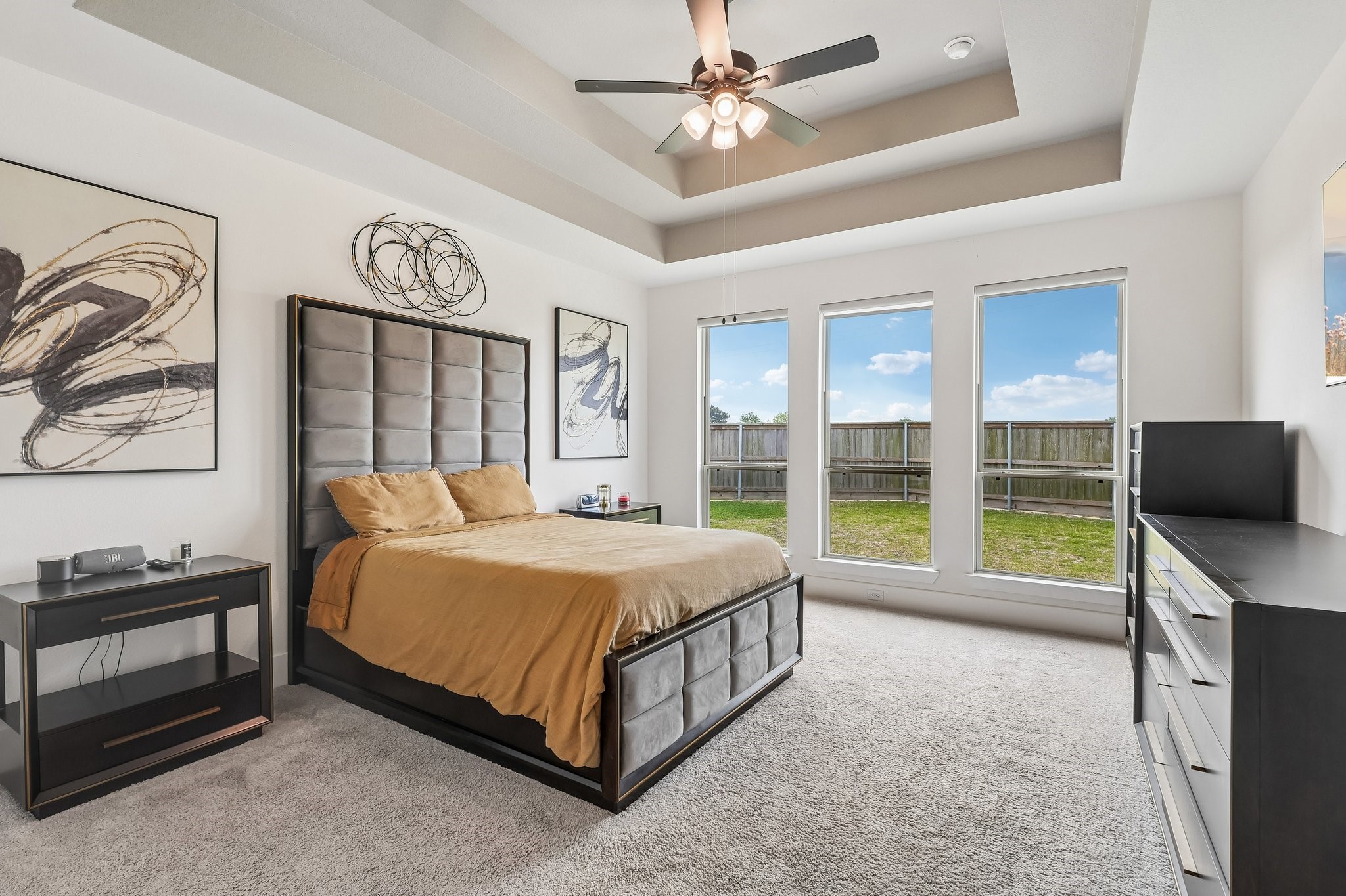 Primary bedroom featuring tray ceiling