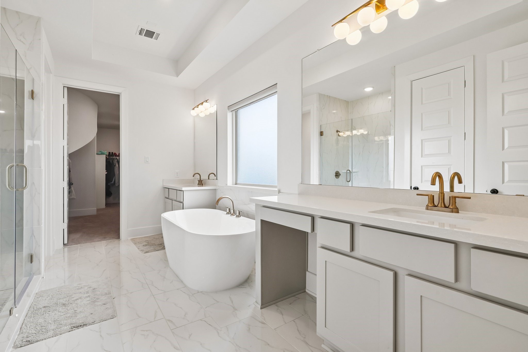 Primary bathroom ensuite, vanity area, connects to the primary closet