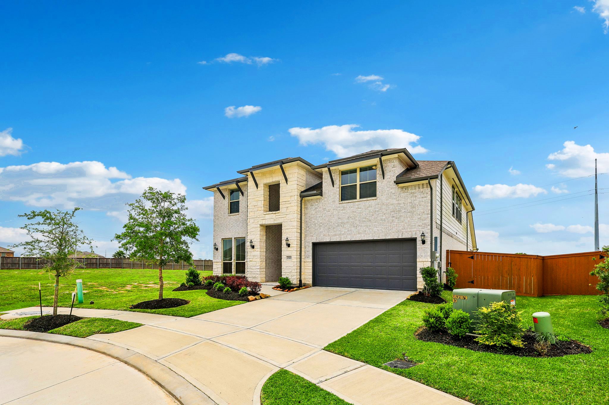 Double wide driveway and 3 car tandem garage