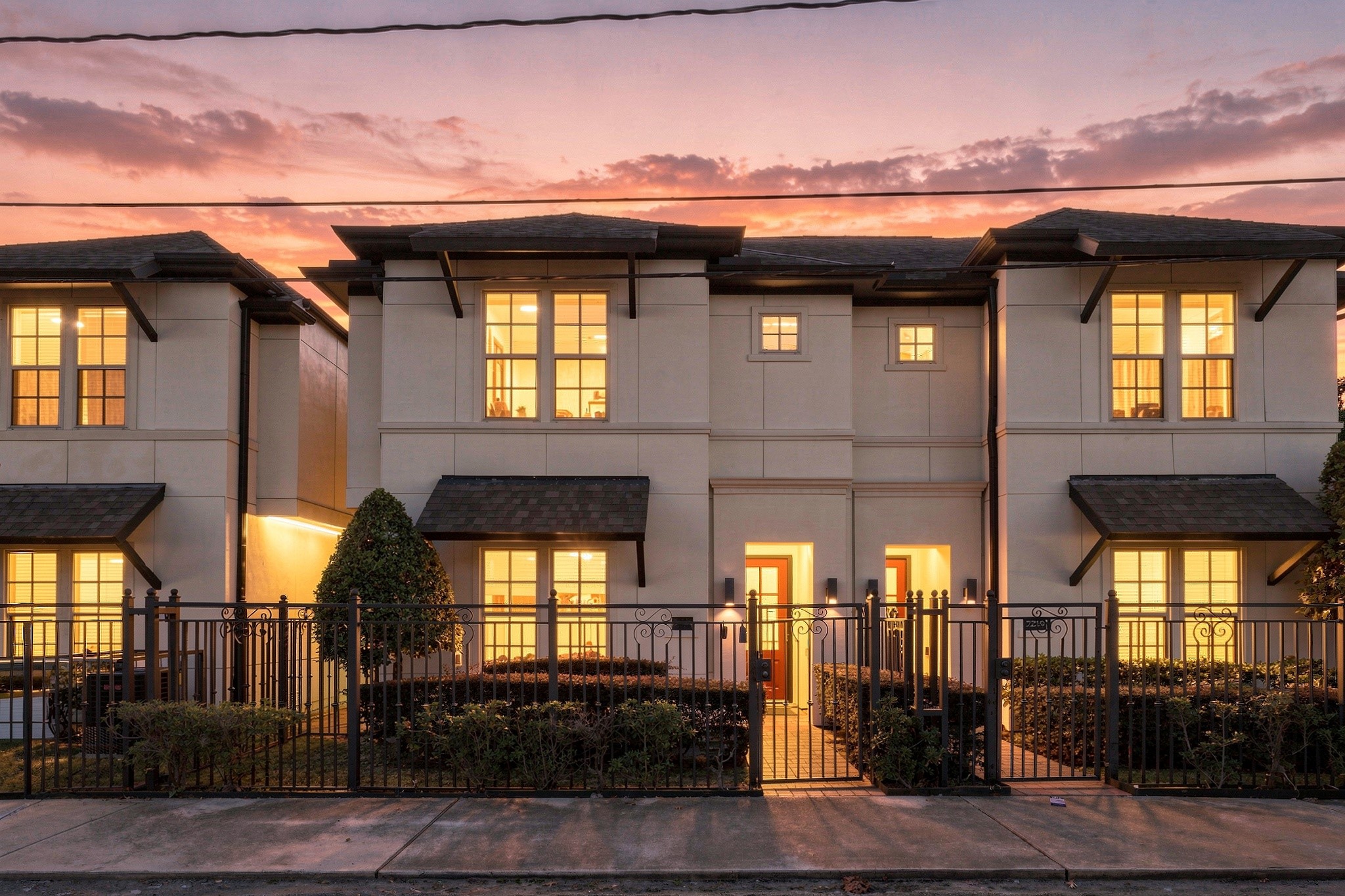 Sunset view of front of townhome.