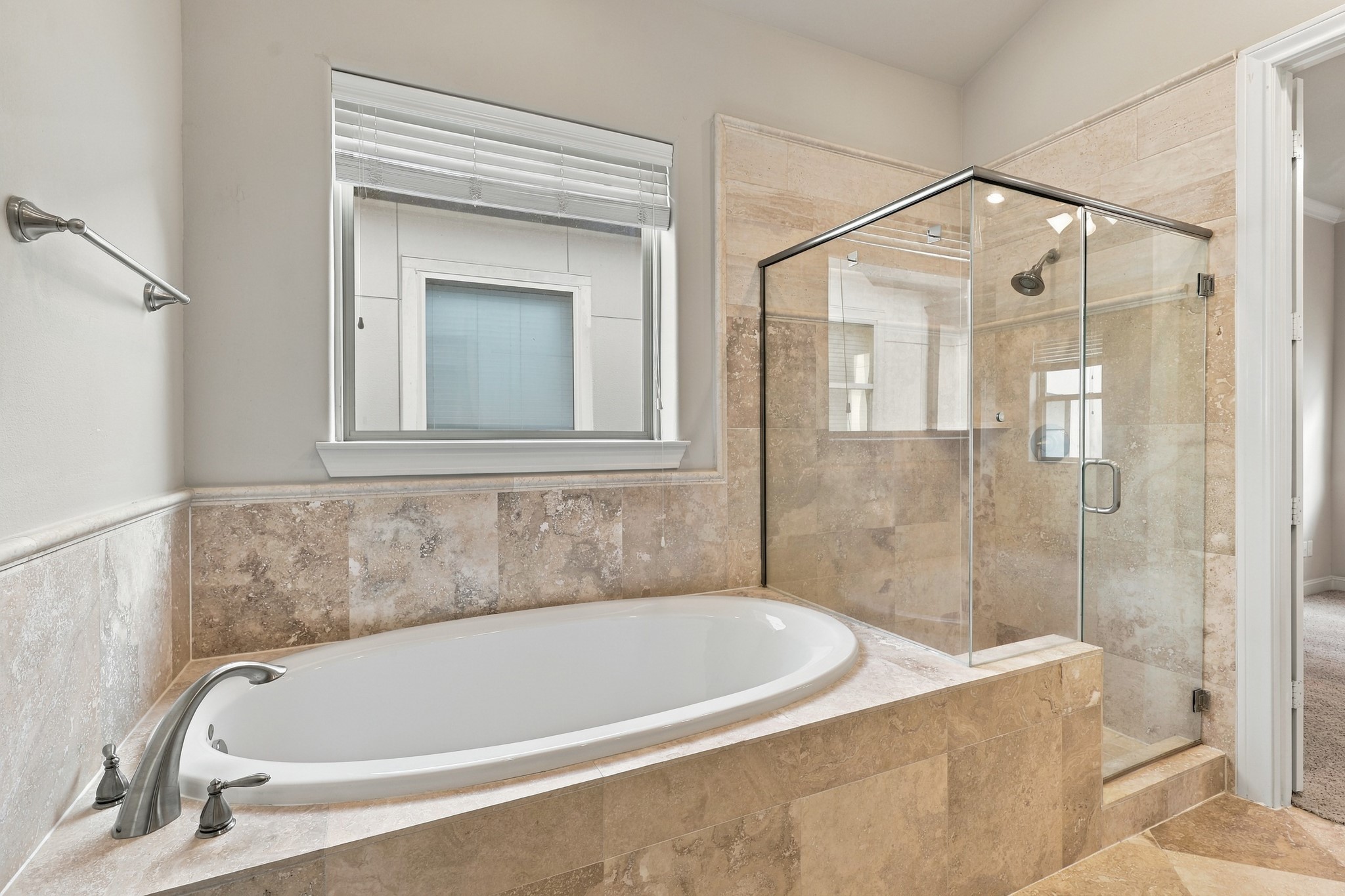 Shower and tub combo in primary bathroom.