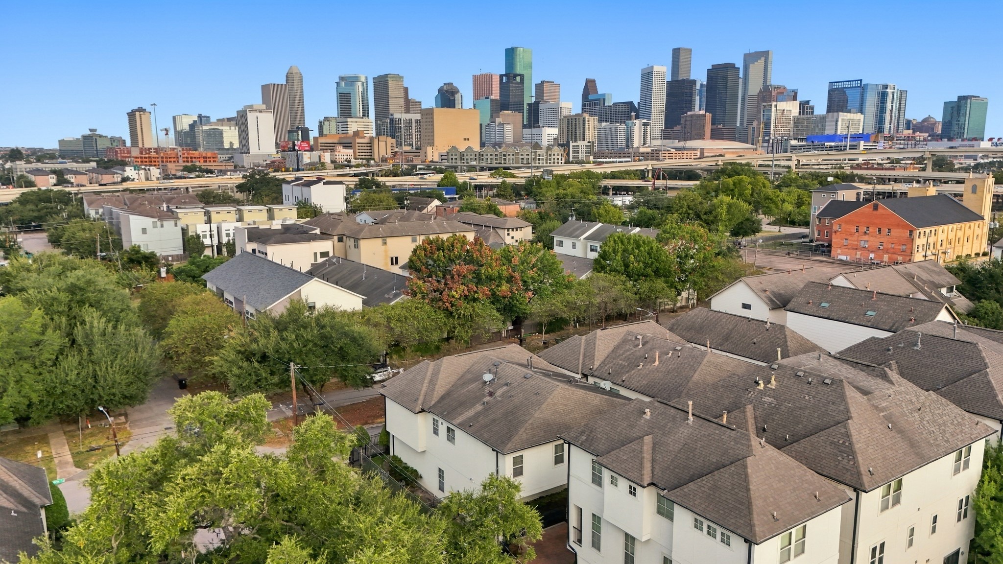Aerial view of townhome with skyline in the back.