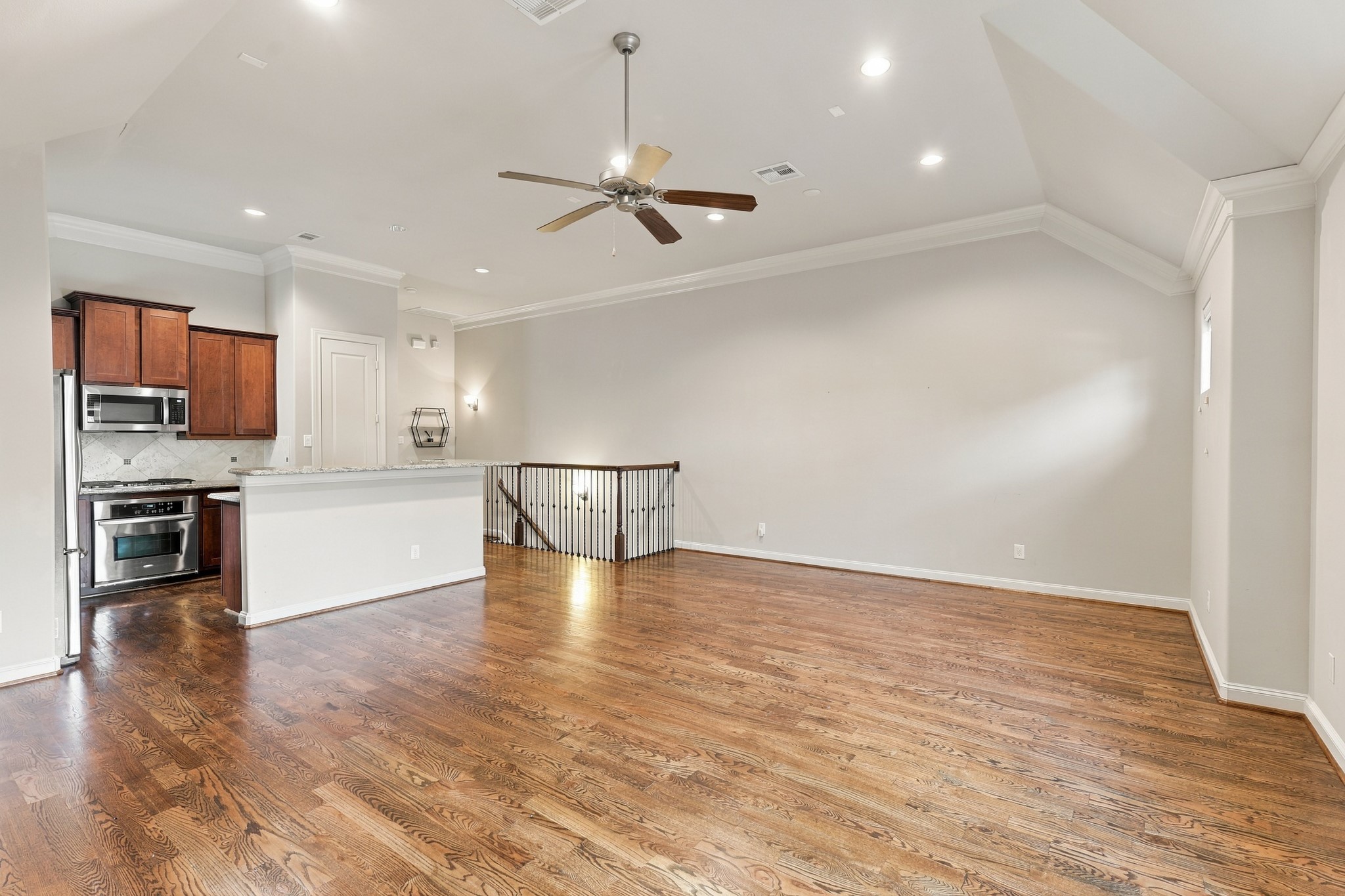 Recessed lights and ceiling fan in second floor living area.