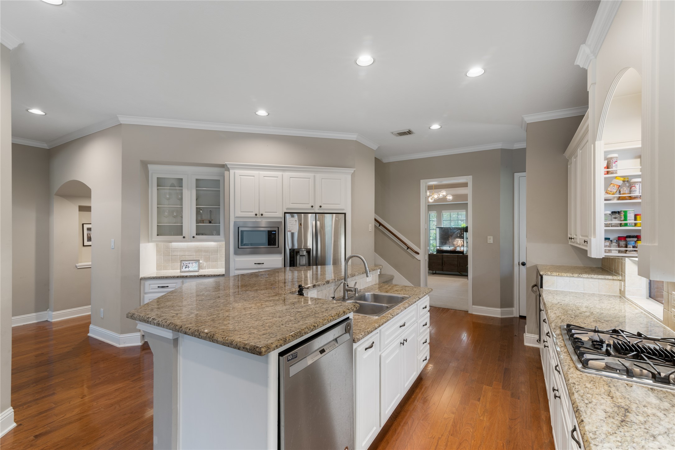Bright, spacious kitchen with gas cooktop and abundant counter space for prepping meals.