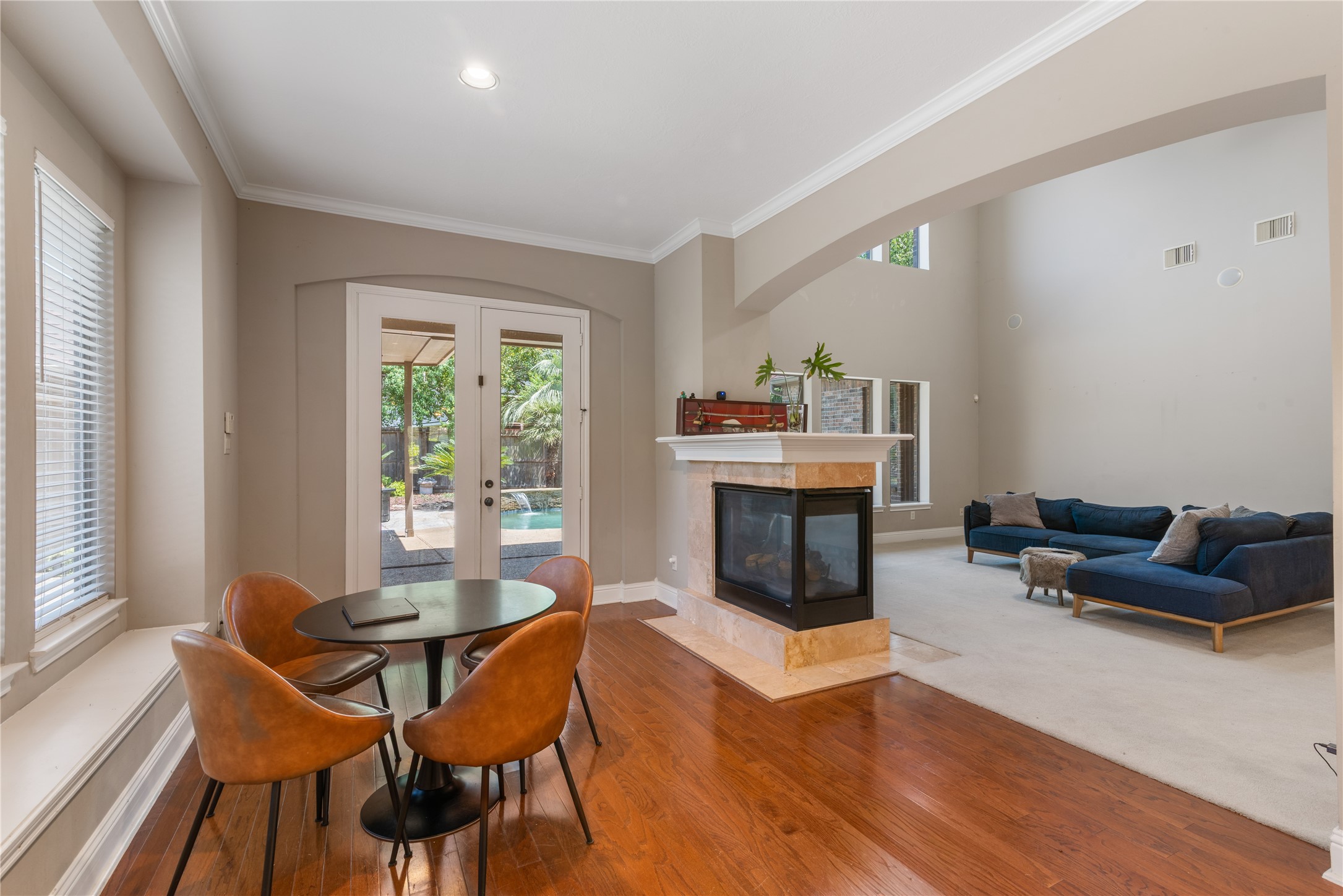 Breakfast room shares a double-sided fireplace with the family room to add warmth and charm while connecting the spaces.