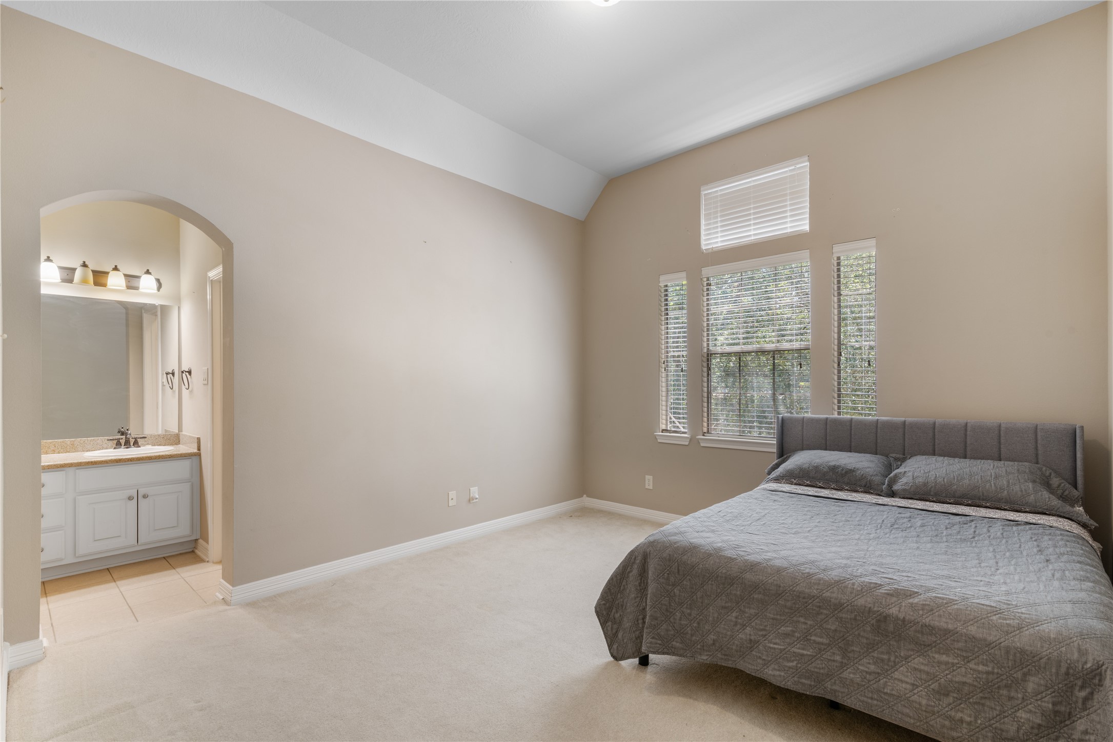 Another secondary bedroom with lots of windows for natural light and adjoining bathroom.