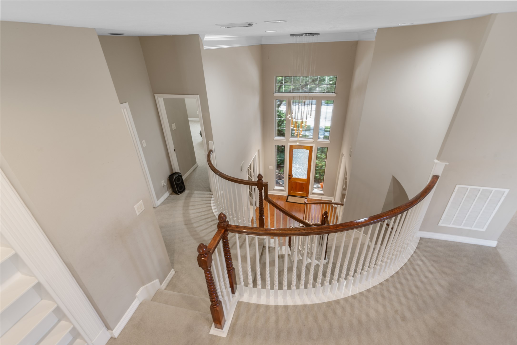 Beautiful view from the upstairs game room.  The open design and high ceilings create a bright, spacious feel, showcasing the home's impressive architectural details and inviting layout.