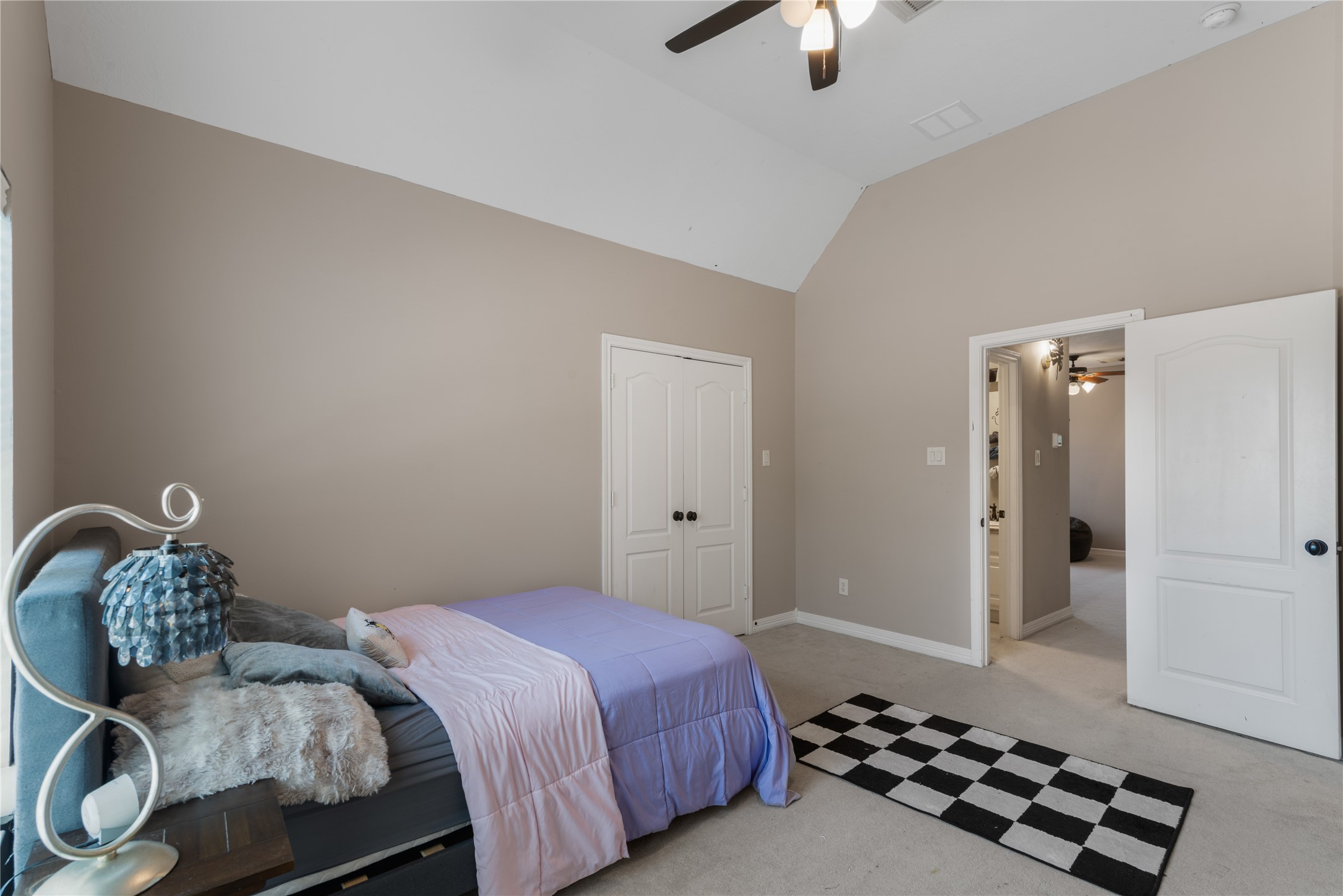 Bright secondary bedroom just off the upstairs game room offers plenty of natural light, making it a comfortable space for guests, children, or a home office.