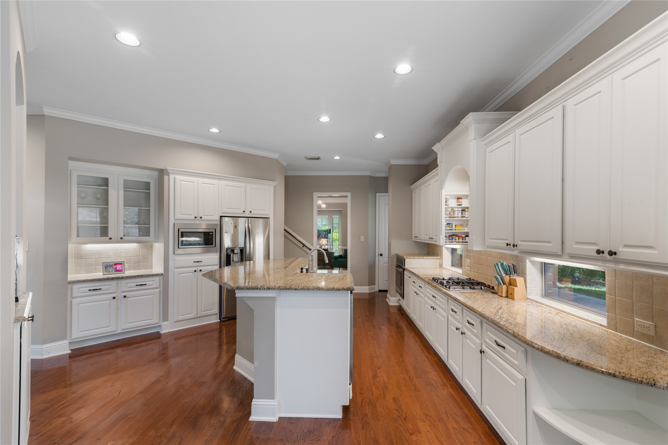 Well-designed kitchen offering abundant storage with extensive cabinetry and under cabinet lights.