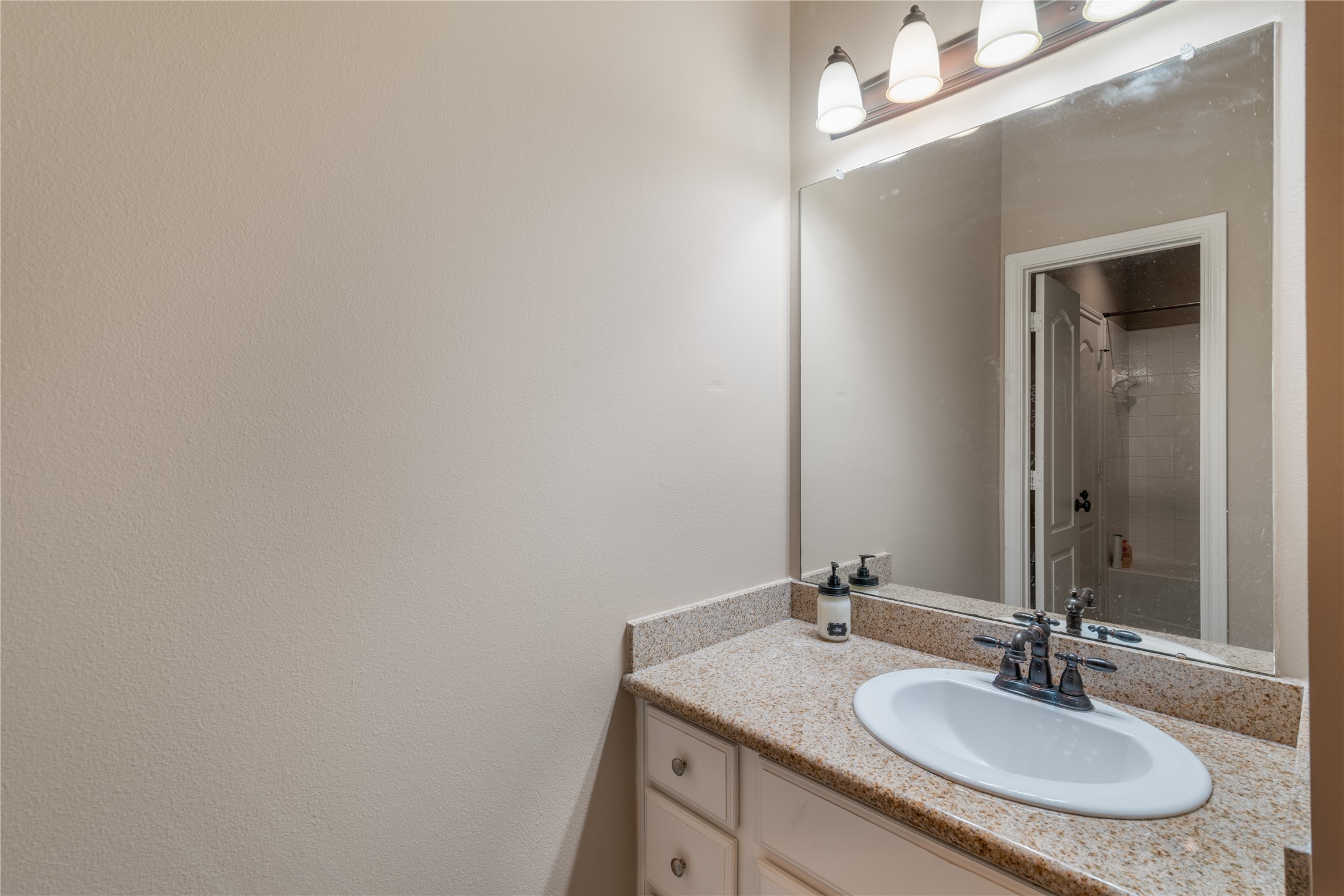 Convenient bathroom featuring a shared layout with separate vanity areas for added privacy.