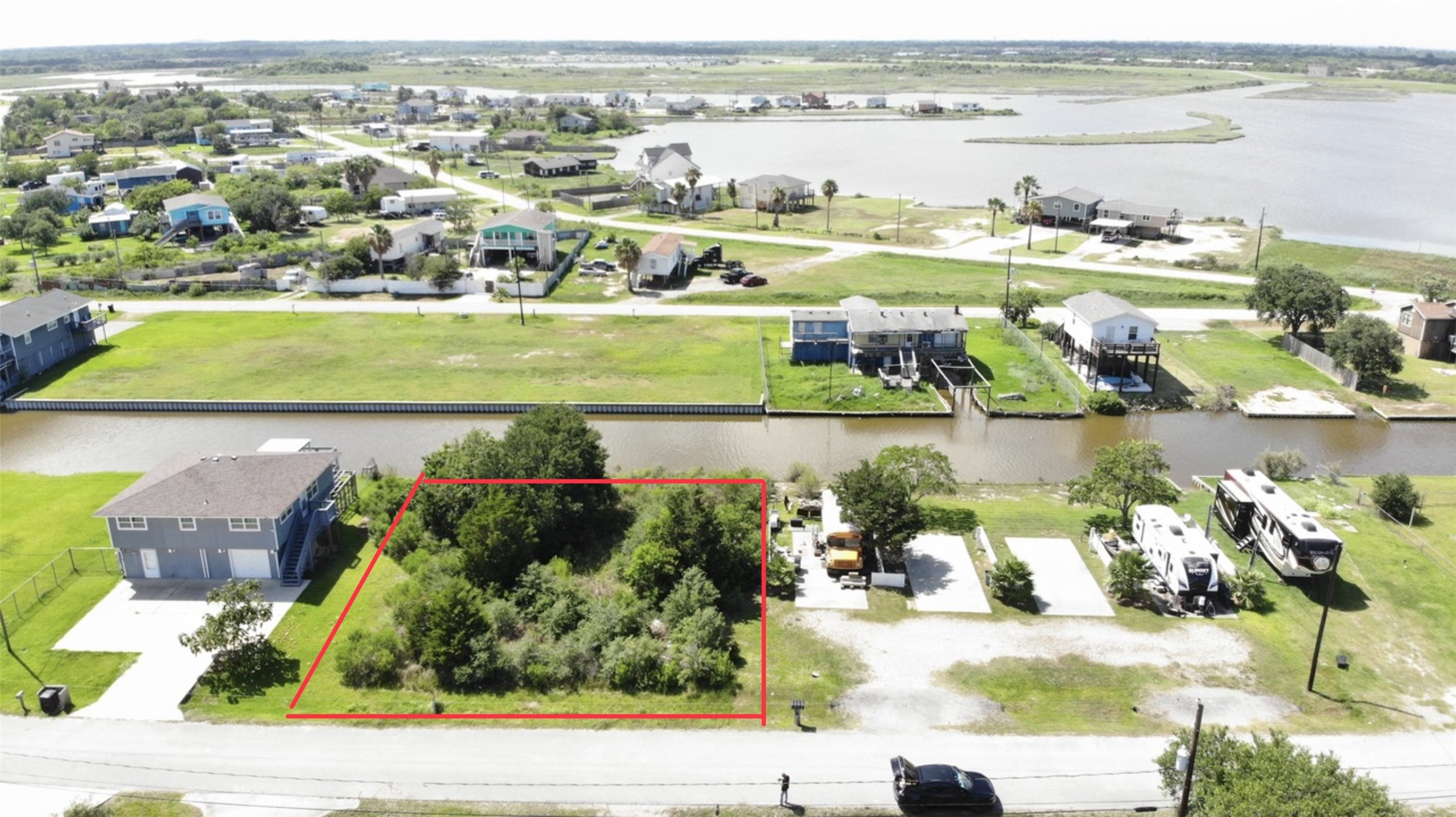 lot outlined in red, situated in a residential area by a canal. The neighborhood features water views, offering a serene setting with easy access to water activities. lot outlined in red, situated in a residential area by a canal. The neighborhood features water views, offering a serene setting with easy access to water activities.