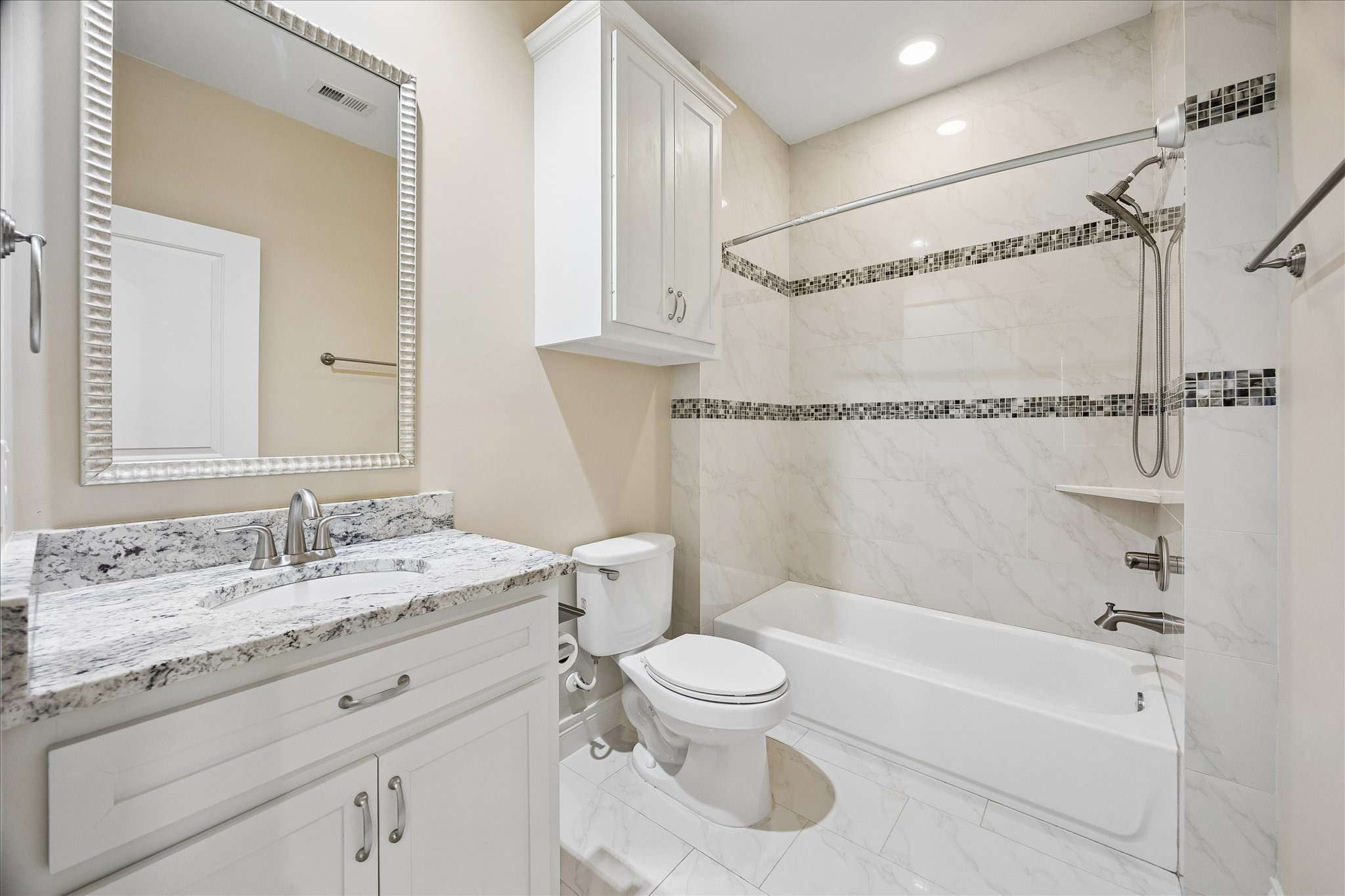 Secondary full bath. This home also offers two powder rooms