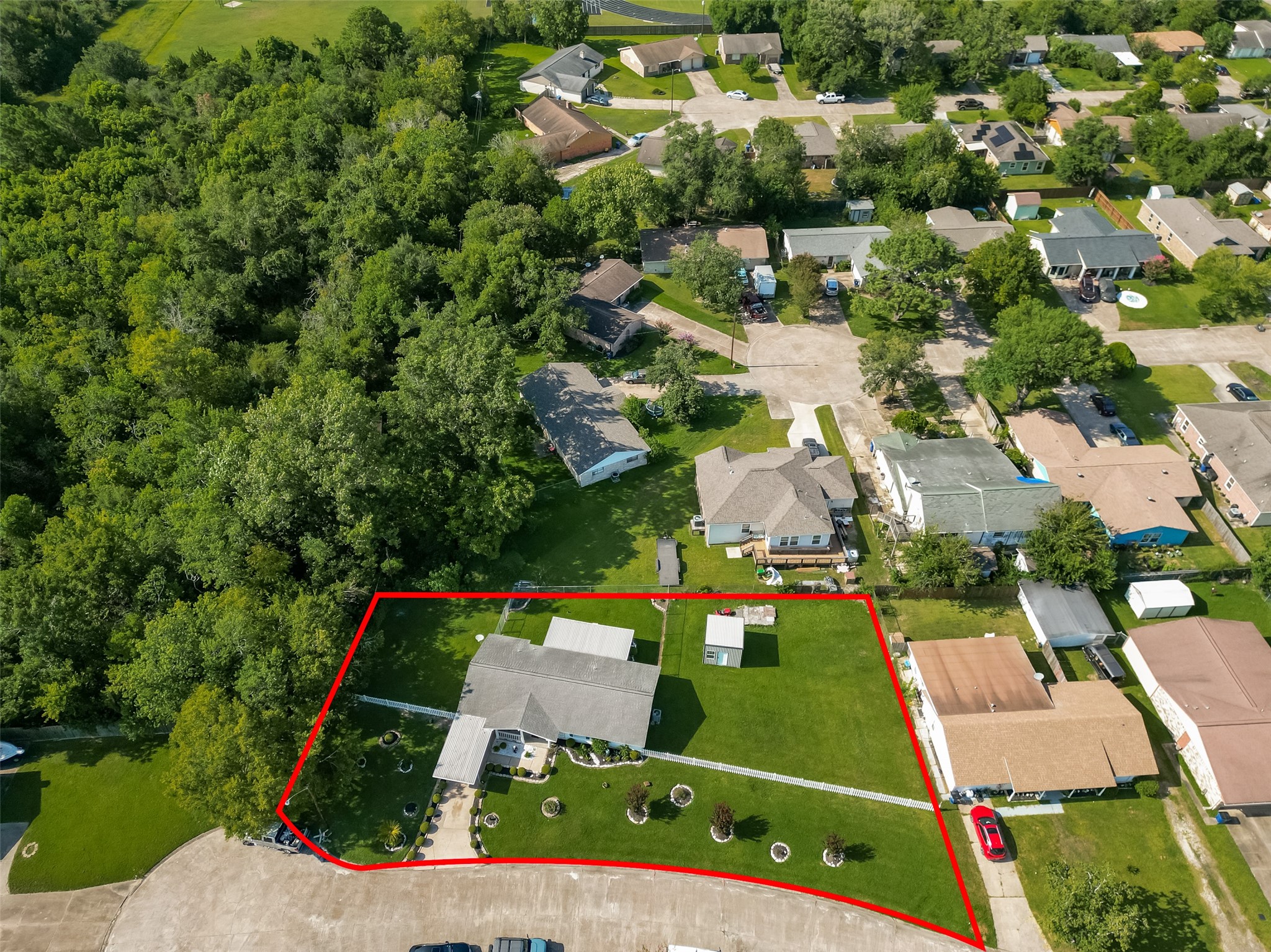 Bird's-eye view highlights the generous lot size, beautifully maintained grounds, and prime location on a quiet cul-de-sac.
For illustration purposes only, the property has been outlined in red to provide a general representation of the lot. Buyers are encouraged to verify property boundaries and dimensions independently.
